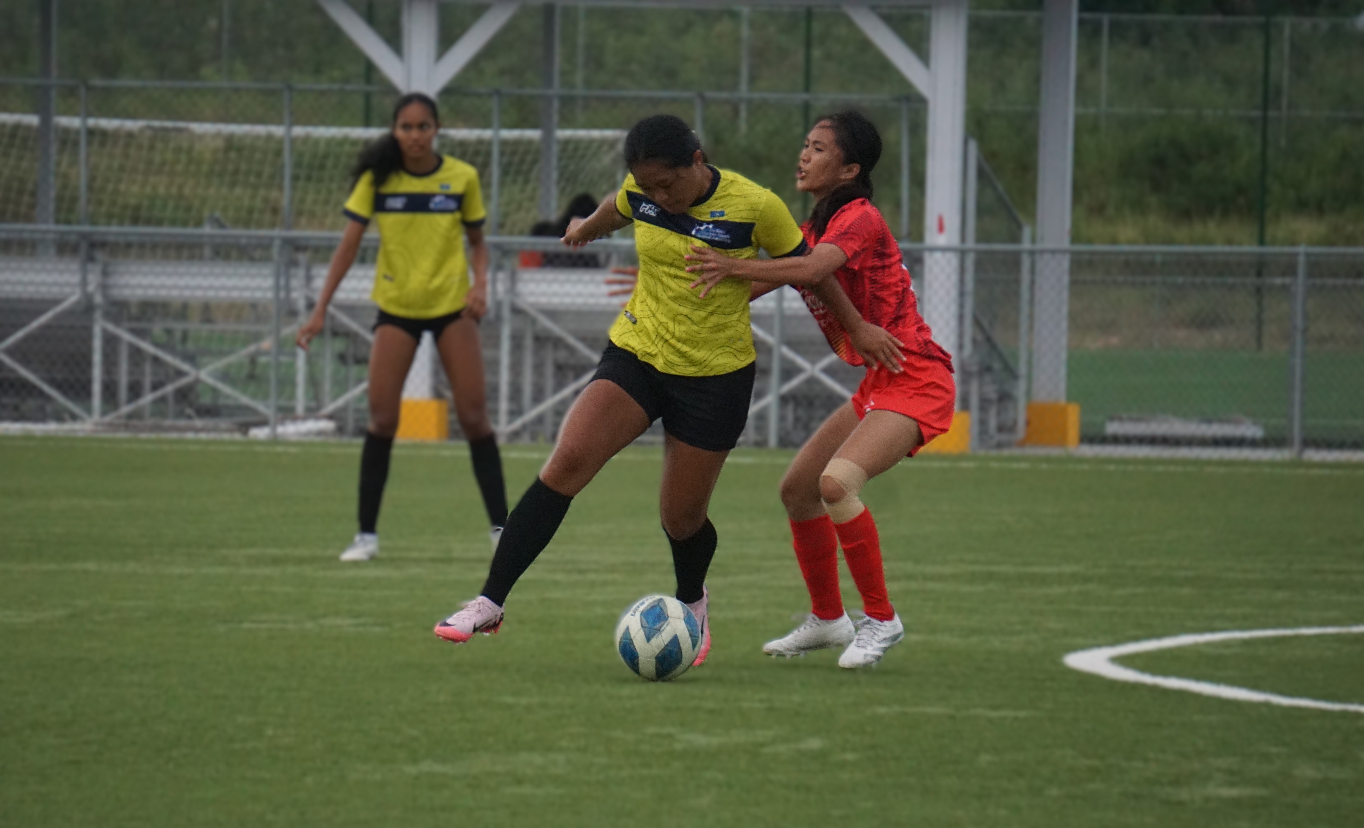 Pia Ngewakl of the NMI Football Association Women’s Team battles for possession against a Tuloy FC Women’s Team player during an LPK Cup match Thursday at the NMI Soccer Training Center in Koblerville.
