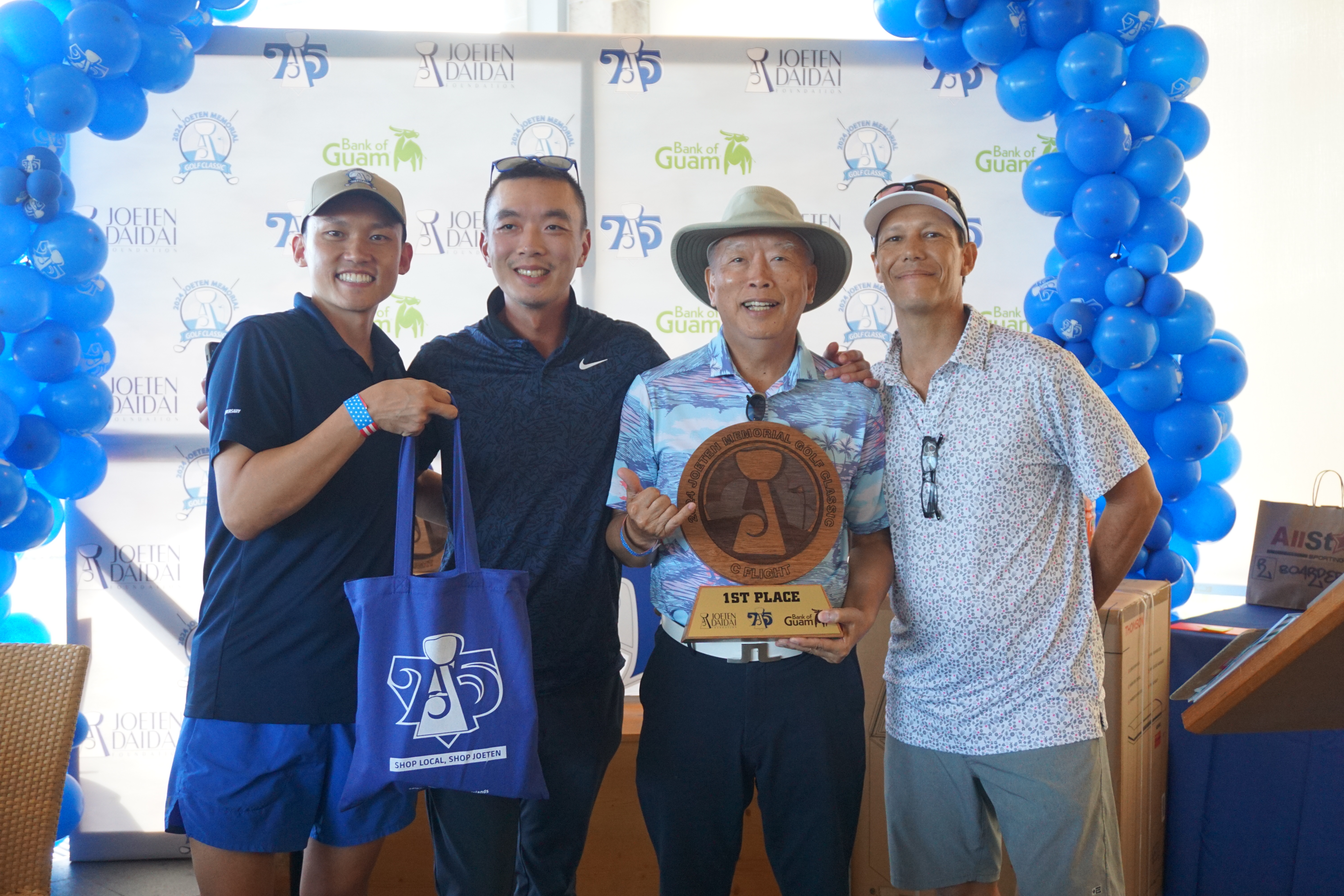 James Lin, 2nd right, holds the C Flight trophy as he poses for a photo with Committee Chair Shigeki Tenorio, left, and Tournament Director Peter "Dung" Tenorio, right, during the awards ceremony of the 2024 Joeten Memorial Classic at Laolao Bay Golf & Resort on Saturday.