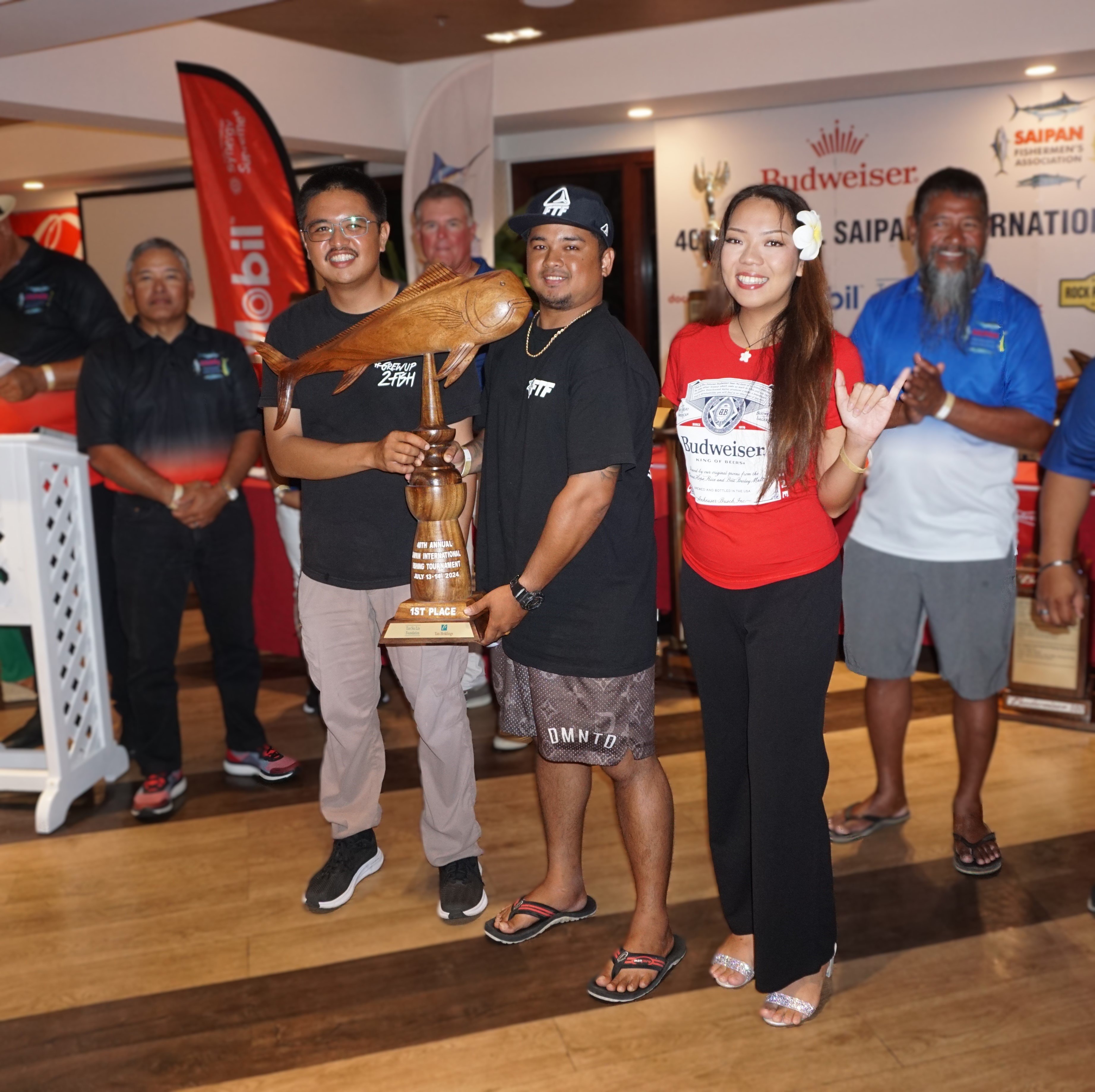 Amber Marie crewmembers pose with the first-place trophy in the mahimahi category of the SFA 40th Annual Saipan International Fishing Derby during the awards banquet at the Pacific Islands Club on Monday.
