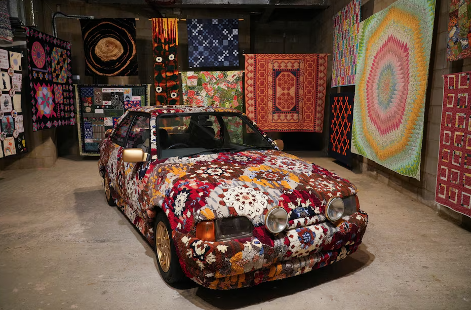 Artist and curator Hetain Patel’s artwork titled "Somerset Road" featuring a Ford Escort tufted by the artist in the pattern of his grandmother’s living room carpet, is displayed together with handmade patchwork quilts as part of the “Come As You Really Are” exhibition in London, Britain, July 17, 2024.