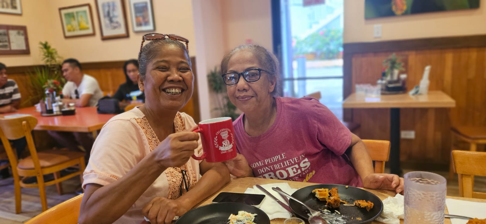 Vicenta Igisomar and Vicky Santos try the new Chicken Meal at Tan Marikita's Café  of Herman's.