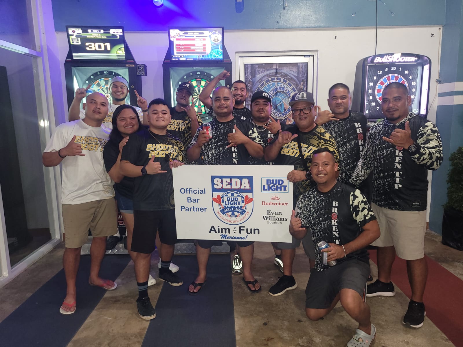 True North Broken Tip and Black8 Shoot It N Boot It players pose for a photo after completing their games in the Thursday B "Flame Tree" Division of the 2024 SEDA Bud Light Dart League at the True North Bar on Thursday.