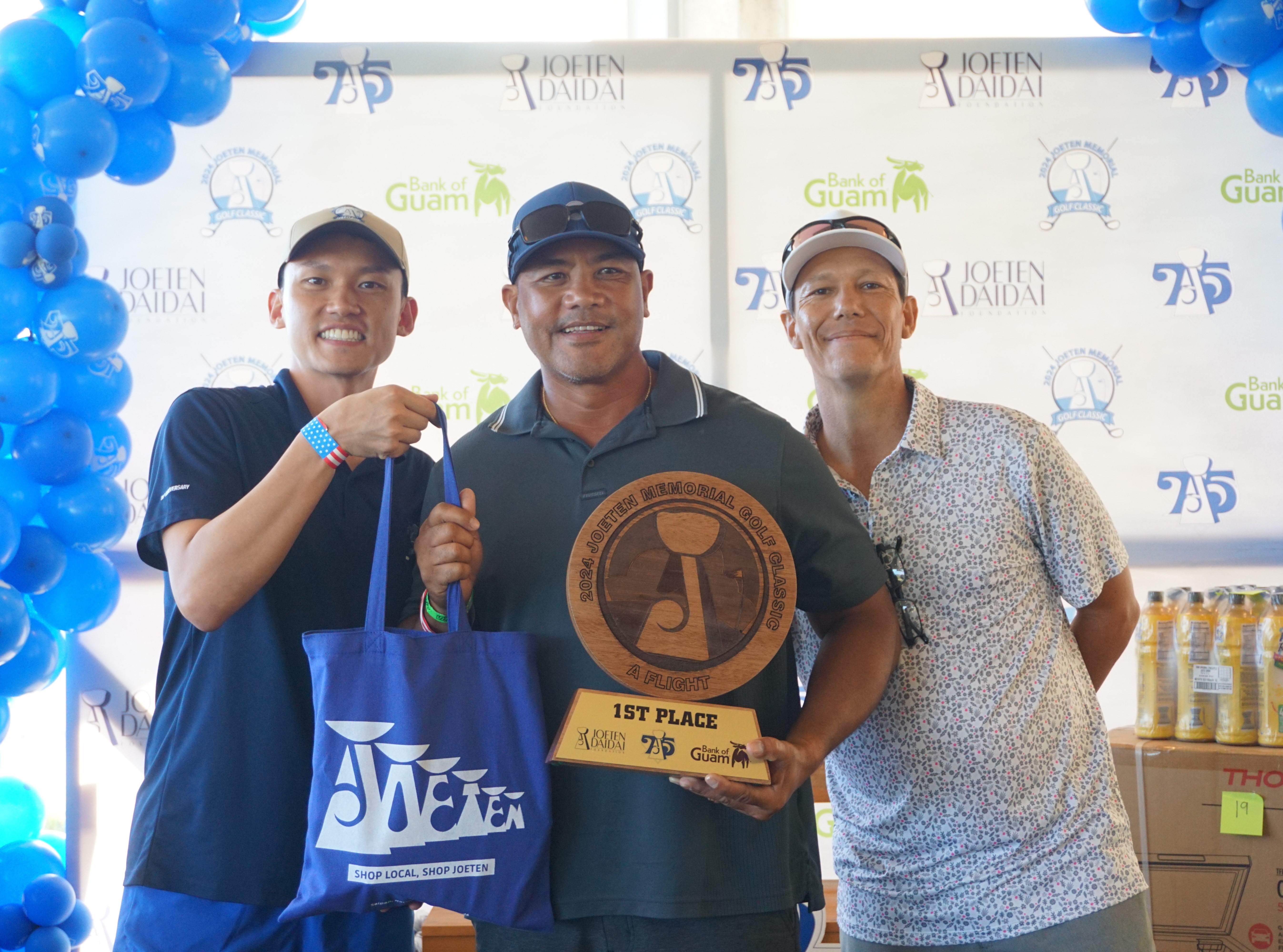 Nick Reyes, center, poses with the A Flight trophy alongside Committee Chair Shigeki Tenorio, left, and Tournament Director Peter "Dung" Tenorio during the awards ceremony of the 2024 Joeten Memorial Classic at Laolao Bay Golf & Resort on Saturday.