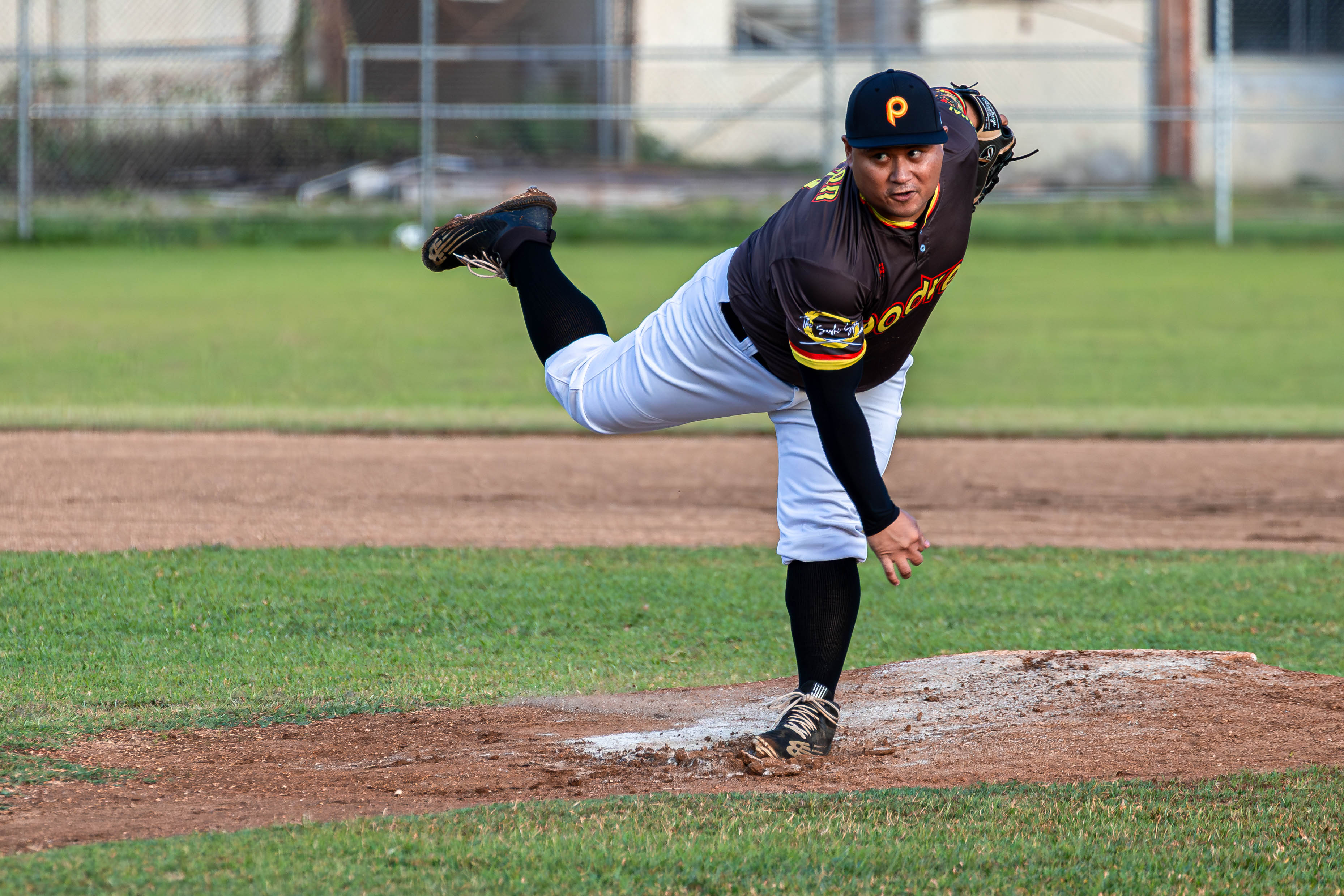 Padre's JP Sablan winds up and sends an offspeed pitch against the Falcons.