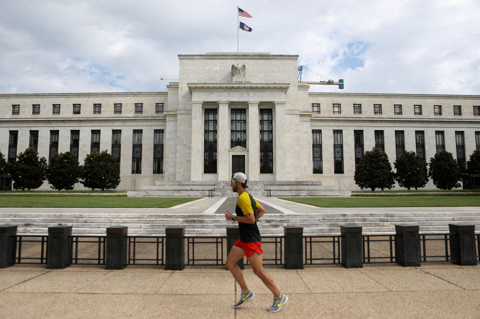 A jogger runs past the Federal Reserve building in Washington, D.C., Aug. 22, 2018.