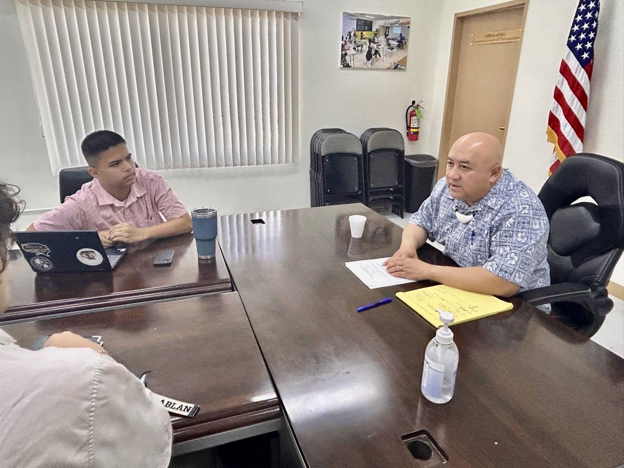 Youth Senator Ayden Sean C. Yumul listens as Commissioner of Education Dr. Lawrence F. Camacho talks about the importance of the Chamorro and Carolinian Language and Heritage Studies Program.