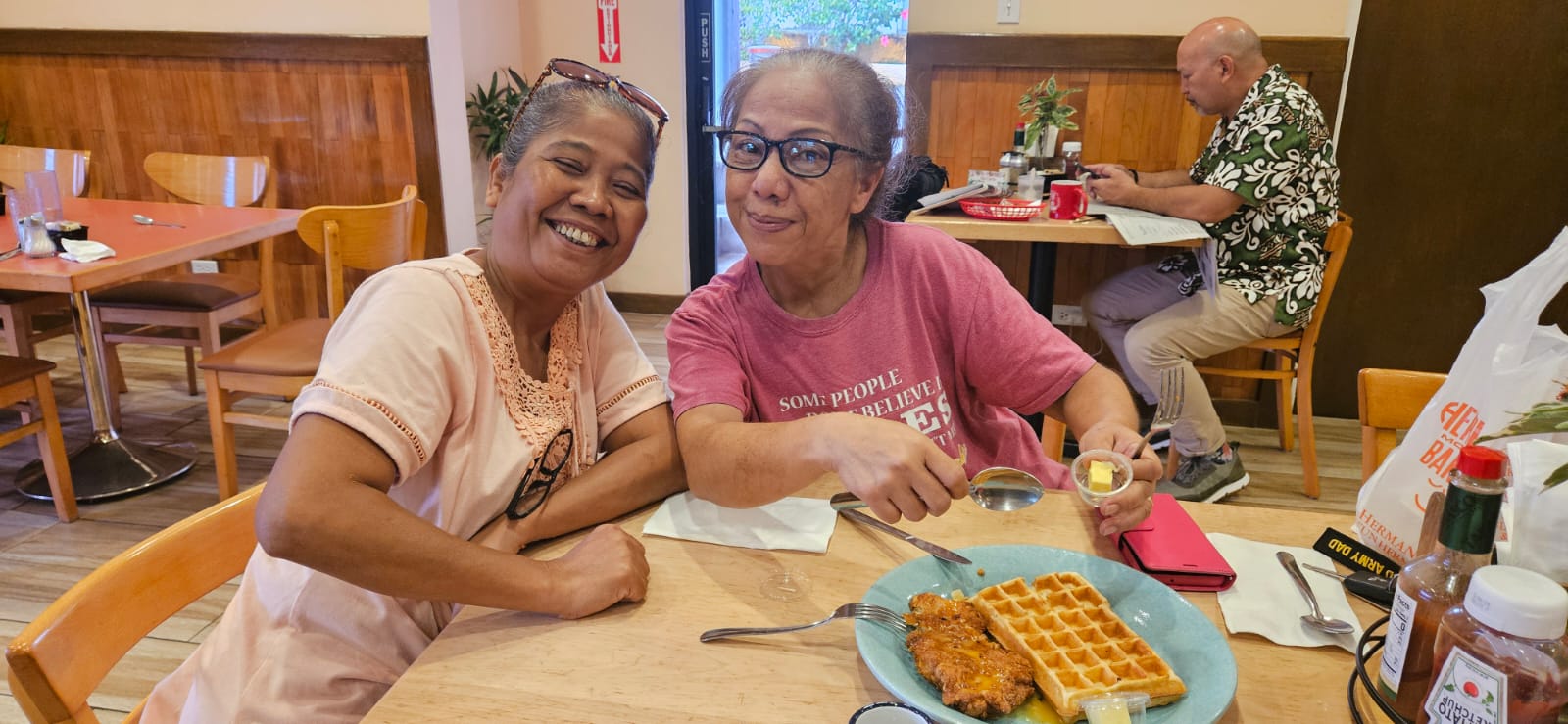 Vicenta Igisomar and Vicky Santos try the new Chicken Meal at Tan Marikita's Cafe of Hermans.