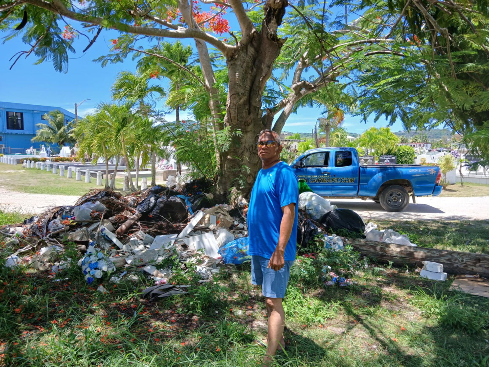 Community volunteer Max Aguon points to illegally dumped trash in the CK cemetery area.