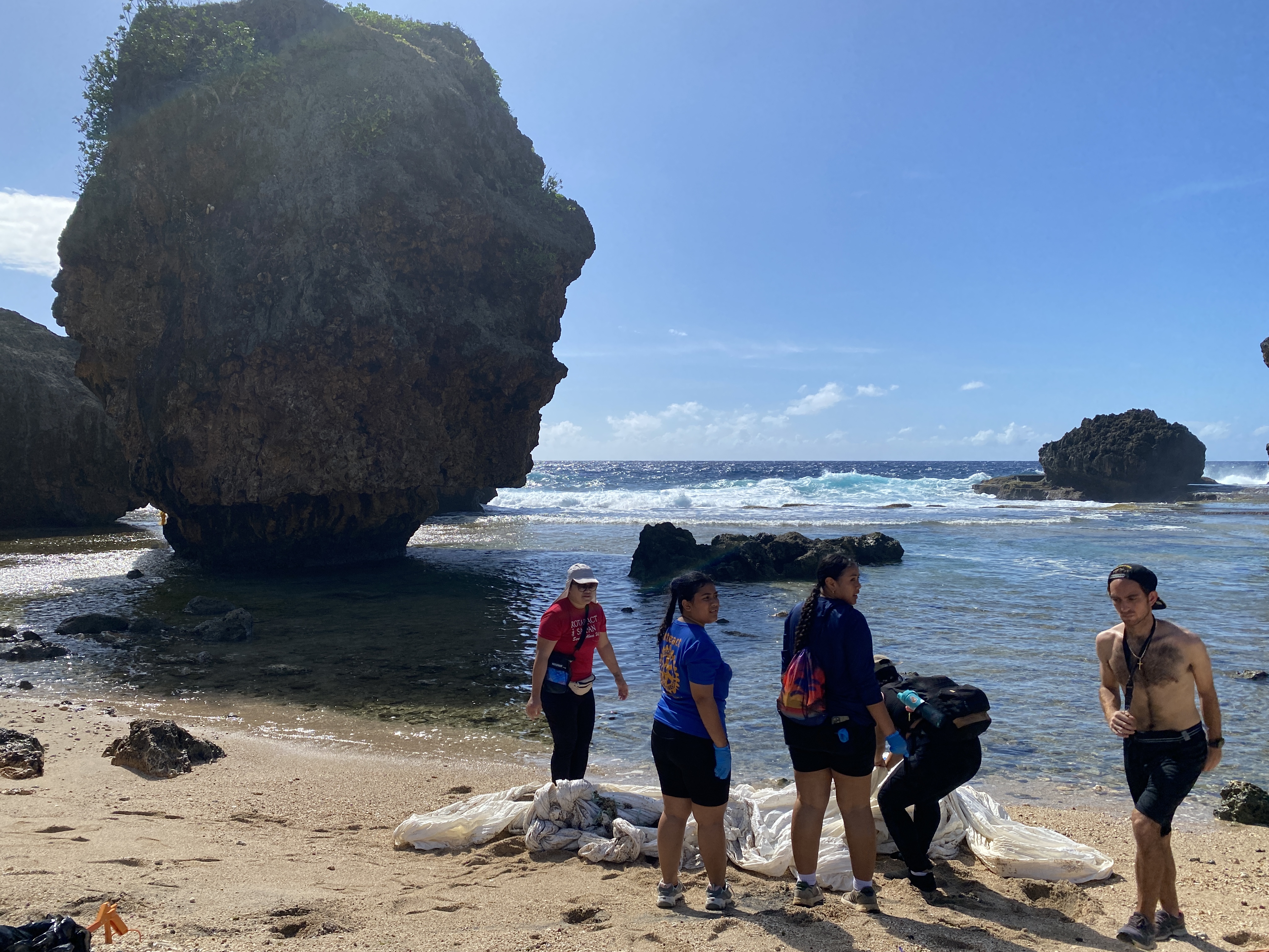 With the iconic Old Man overlooking their activities, volunteers clean up the beach area.  