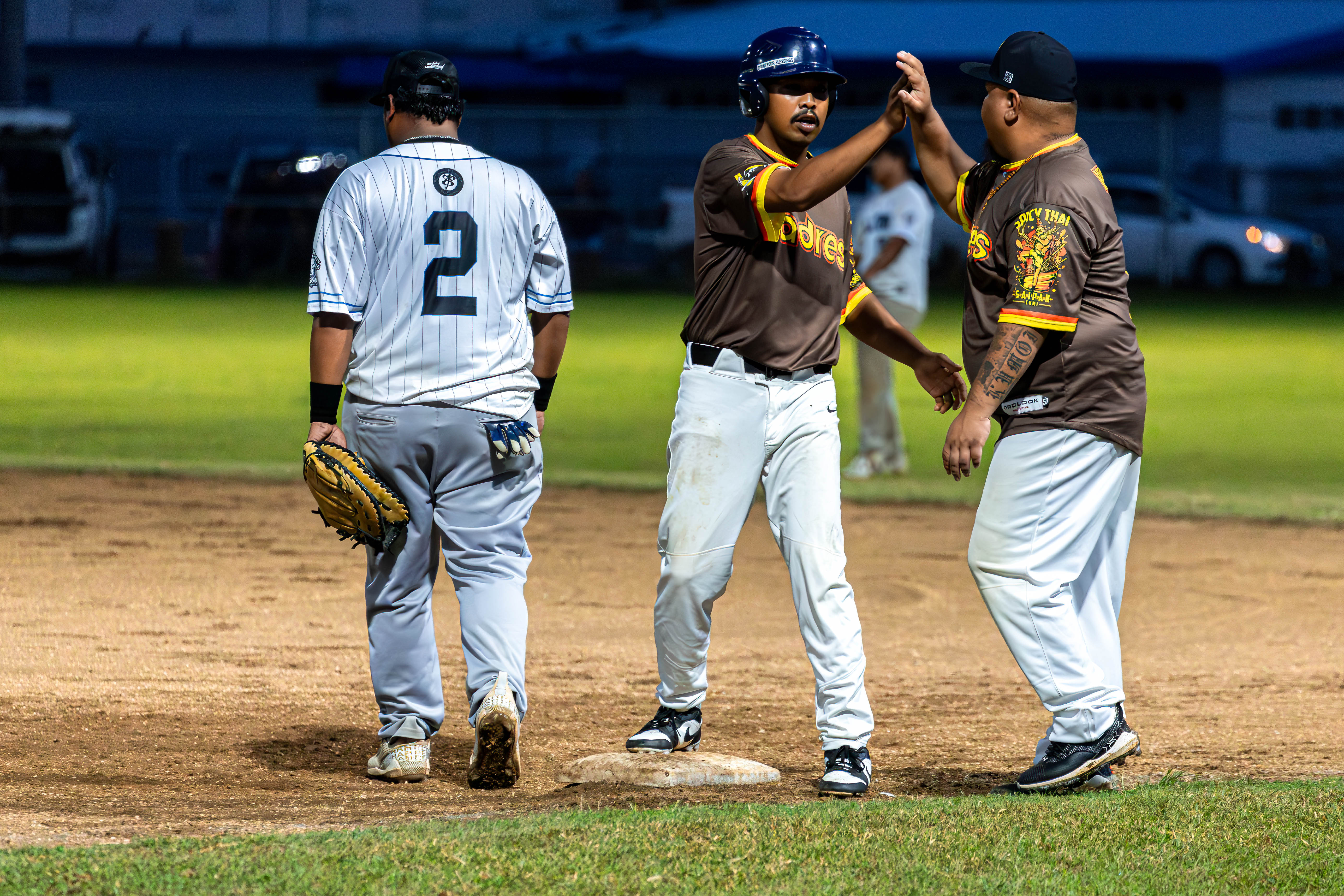 Padre's Kolby Lifoifoi high-fives his base coach off a solid hit against the Falcons.