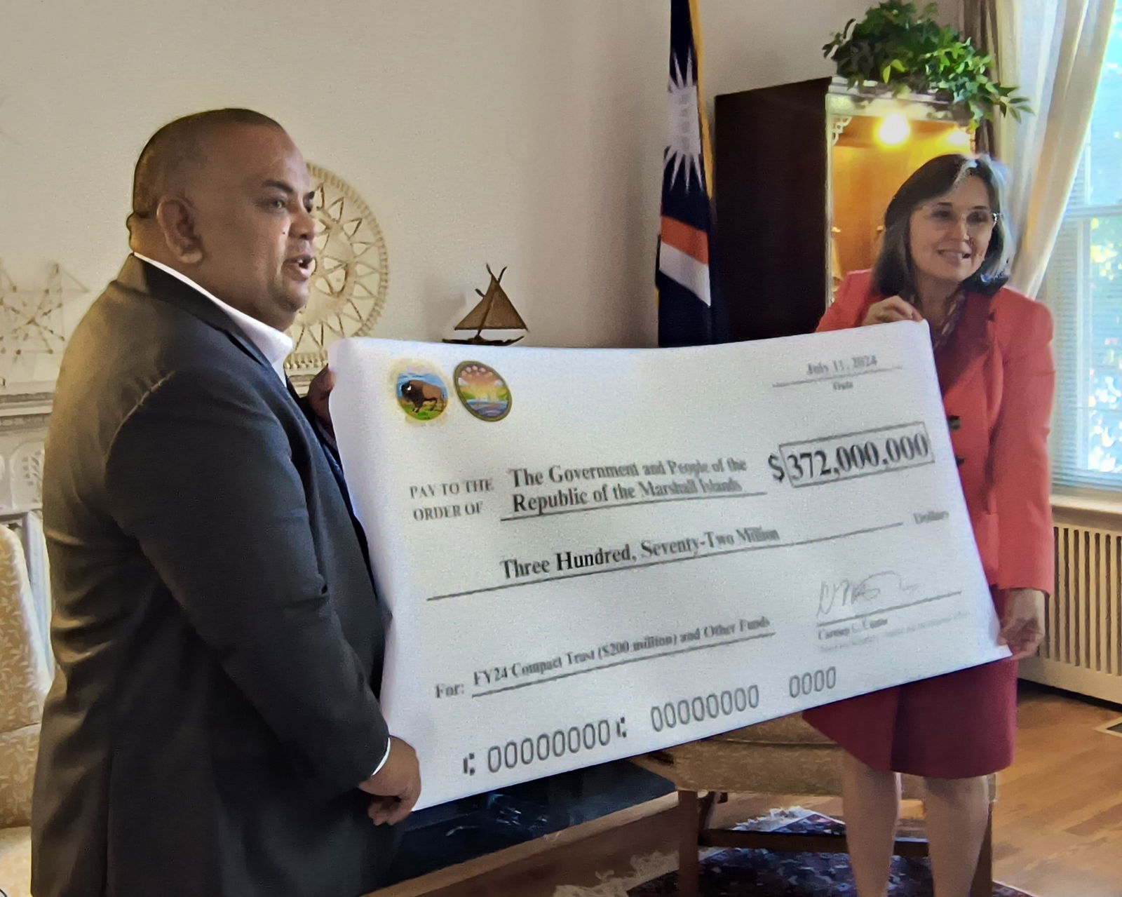 Marshall Islands Ambassador to the U.S. Charles Paul and Interior’s Assistant Secretary for Insular and International Affairs Carmen G. Cantor hold  a ceremonial check for $372 million.