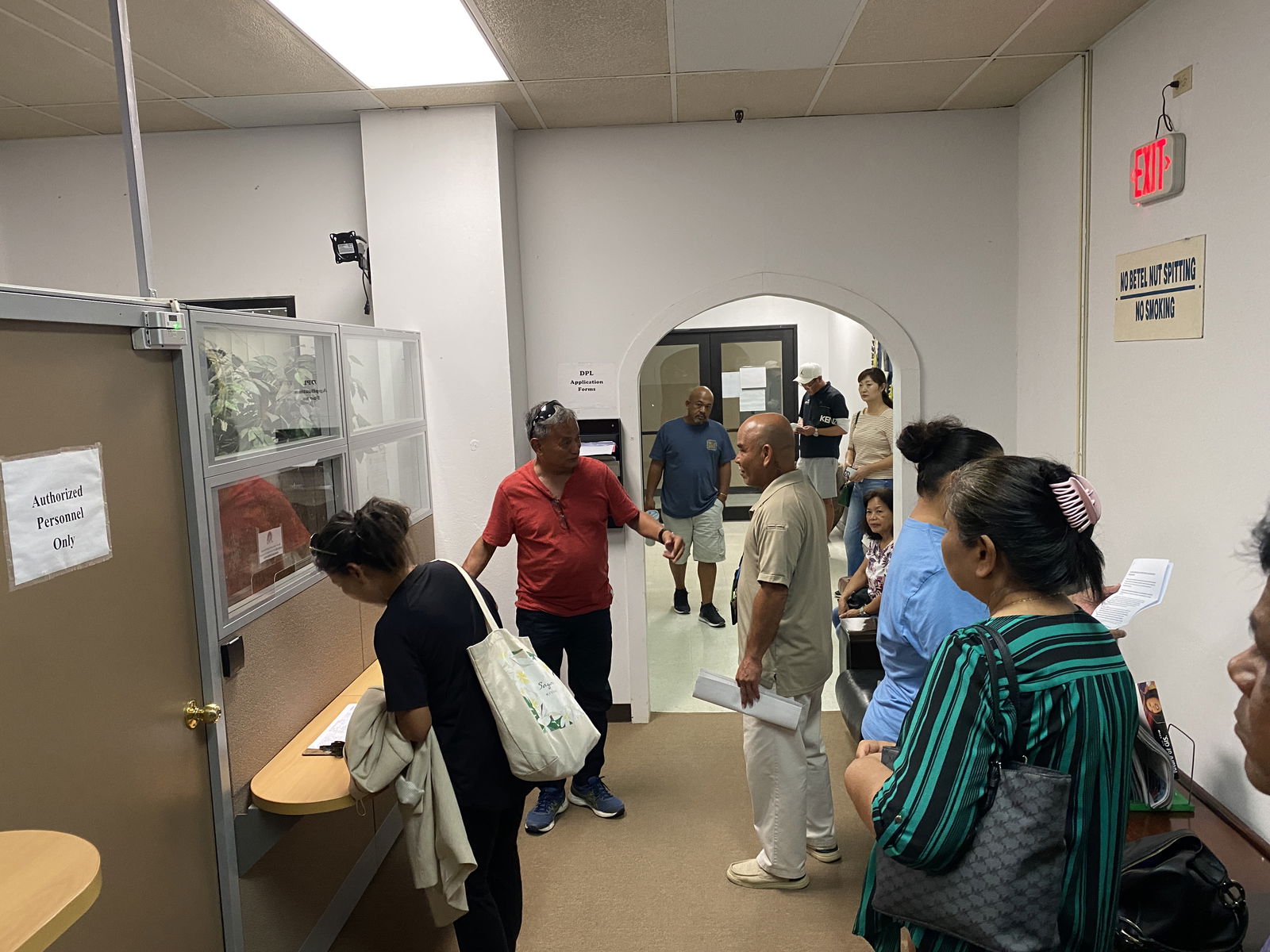 Marine sports vendors wait for the start of a closed-door meeting with the Department of Public Lands ​ 