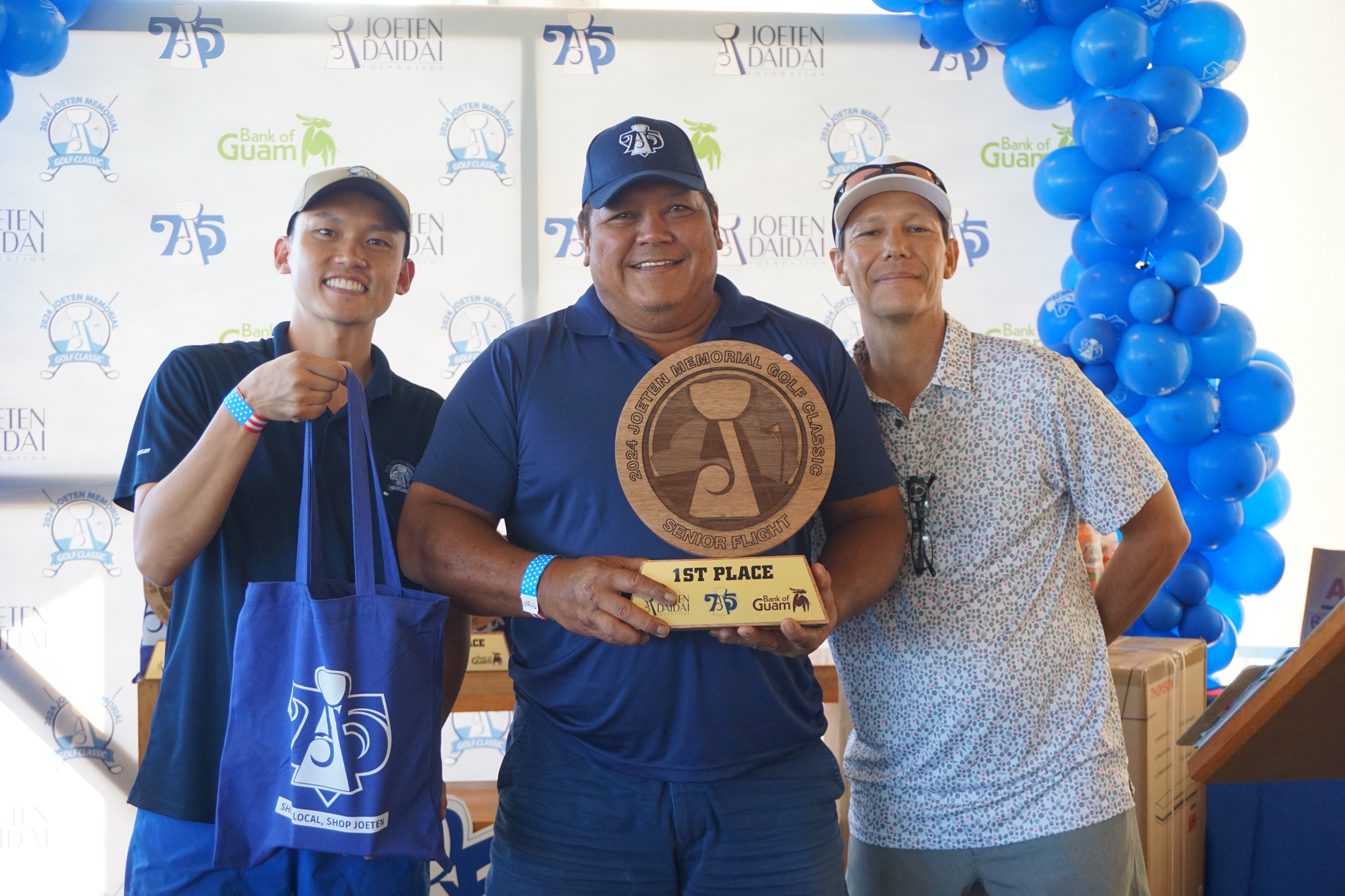 Anthony Benavente, center, poses with the Senior Flight trophy alongside Committee Chair Shigeki Tenorio, left, and Tournament Director Peter "Dung" Tenorio during the awards ceremony of the 2024 Joeten Memorial Classic at Laolao Bay Golf & Resort on Saturday.