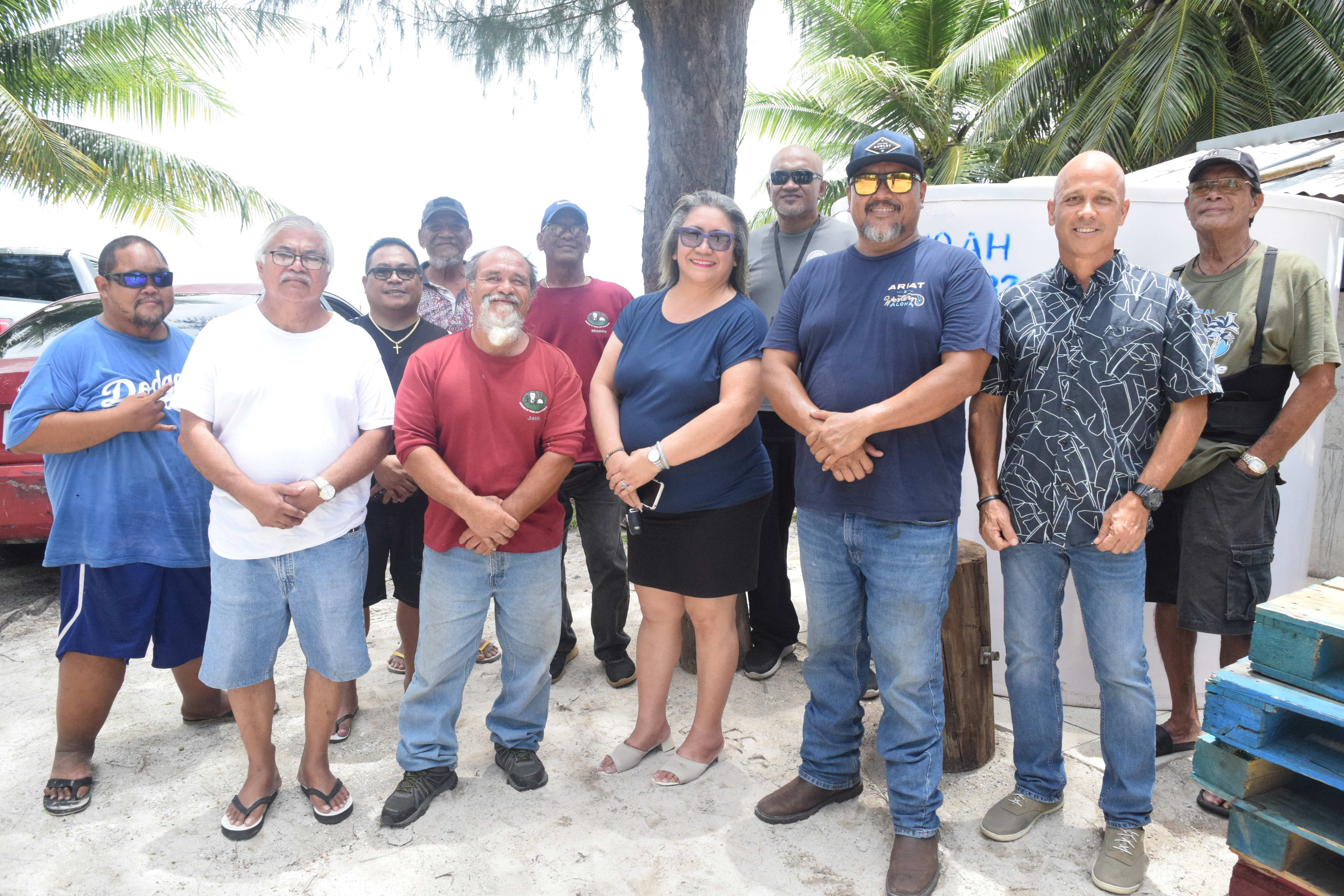 Senate President Edith Deleon Guerrero, center, Bantalan Sugar Dock Inc. President Keith Ada, third right, the group's senior adviser, former Rep. Martin B. Ada, second left and other members of the organization pose next to the new 1,000-gallon water tank at Sugar Dock Beach on Wednesday.