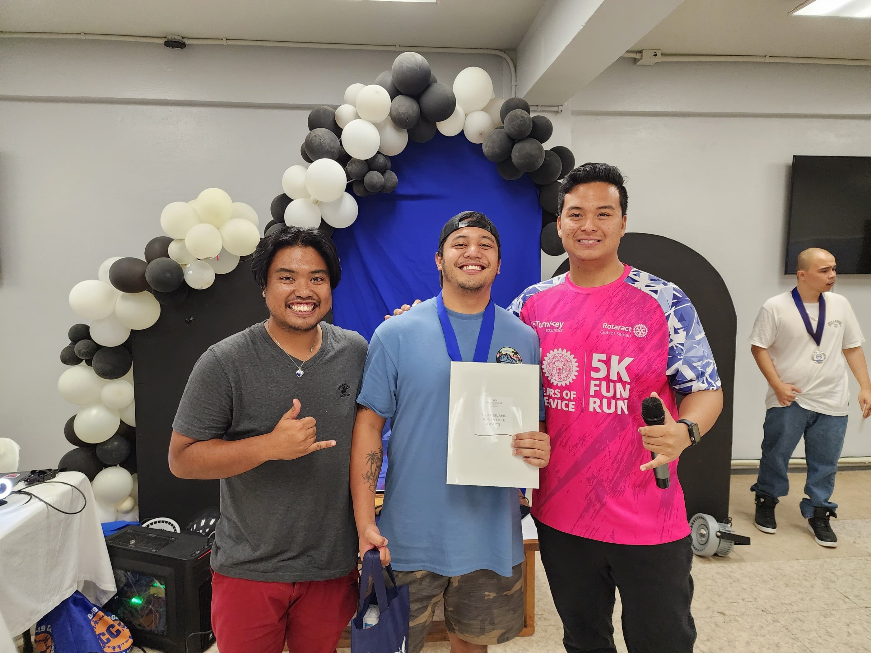 Two-time winner Lance "Ponpon" Rasa poses with Rotaract Club of Saipan President Richard Baleares and tournament committee head Simon Necesito during the awards ceremony of Summer Showdown Vol. 2 at Pepoy’s Café & Restaurant in Susupe on Saturday.