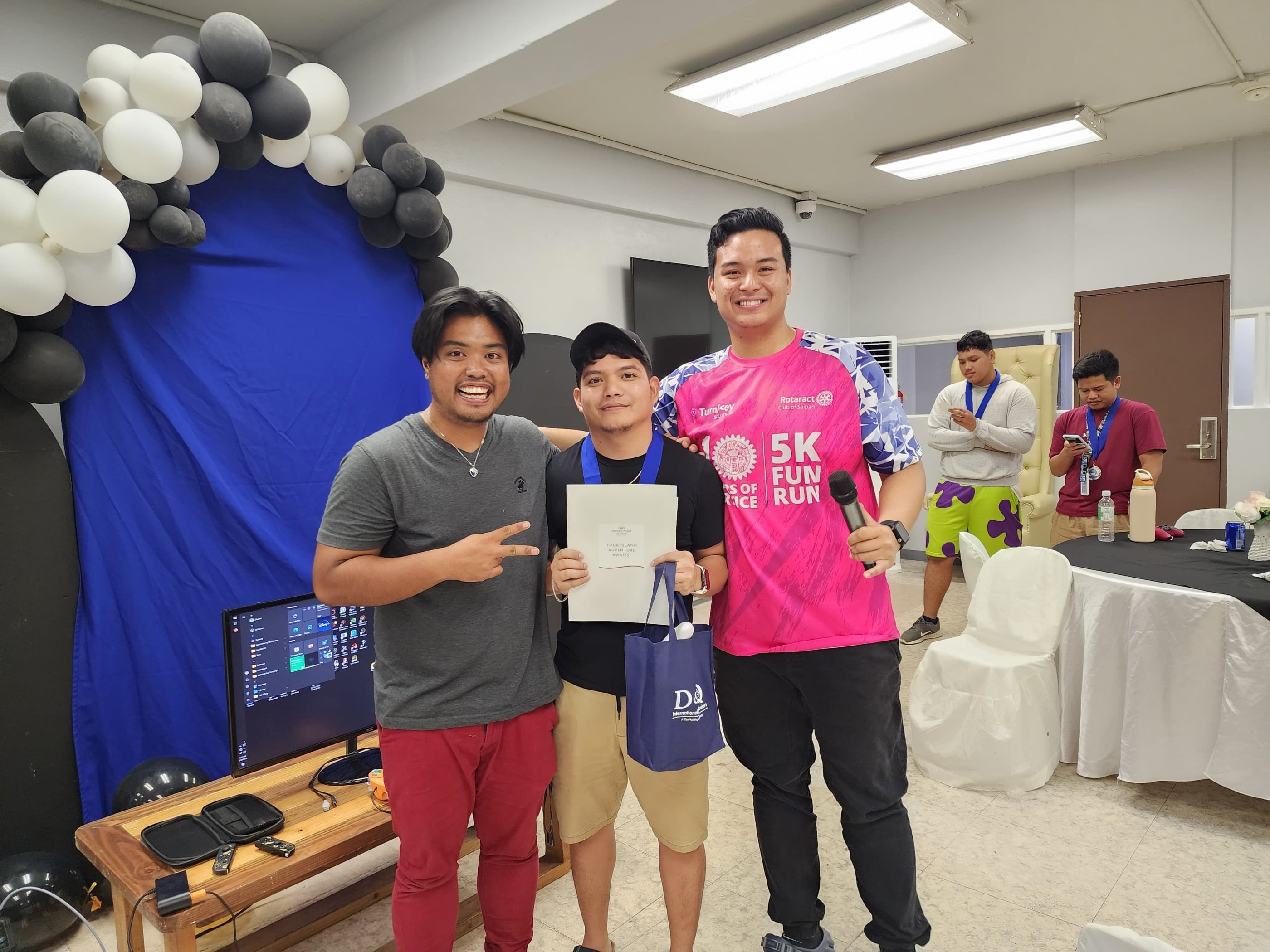 Raybrent Iglecias, the two-time Super Smash Bros. champion,  poses with Rotaract Club of Saipan President Richard Baleares, right, and committee head Simon Necesito, left, at the conclusion of the Rotaract Club of Saipan's Summer Showdown Vol .2 at Pepoy’s Café and Restaurant on Saturday.