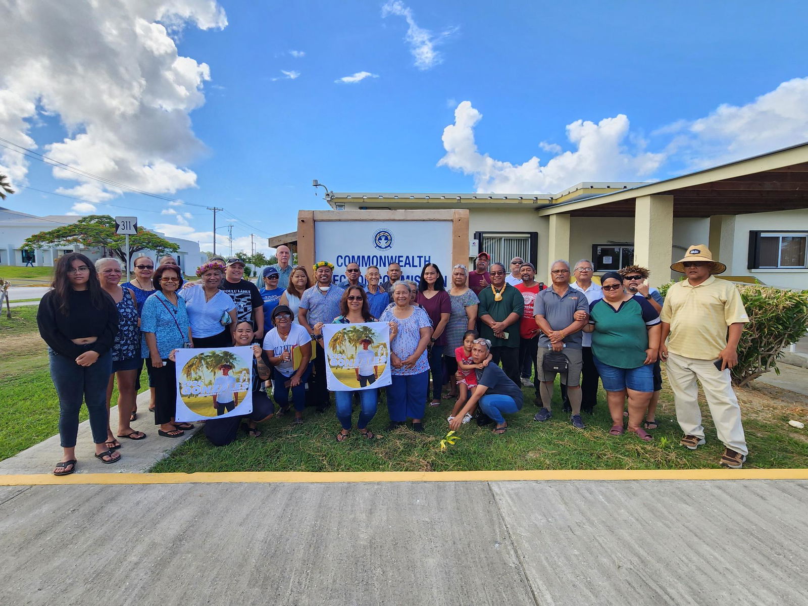 John Oliver Gonzales poses for a photo with his campaign committee, family members and other supporters after filing his independent candidacy for the U.S. Congress at the Commonwealth Election Commission on Monday morning. 