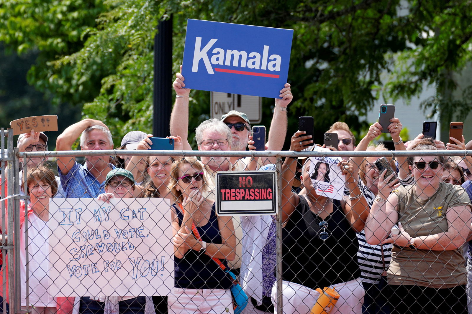 Supporters hold signs before Vice President Kamala Harris arrives to deliver remarks at a campaign event in Pittsfield, Mass., July 27, 2024.