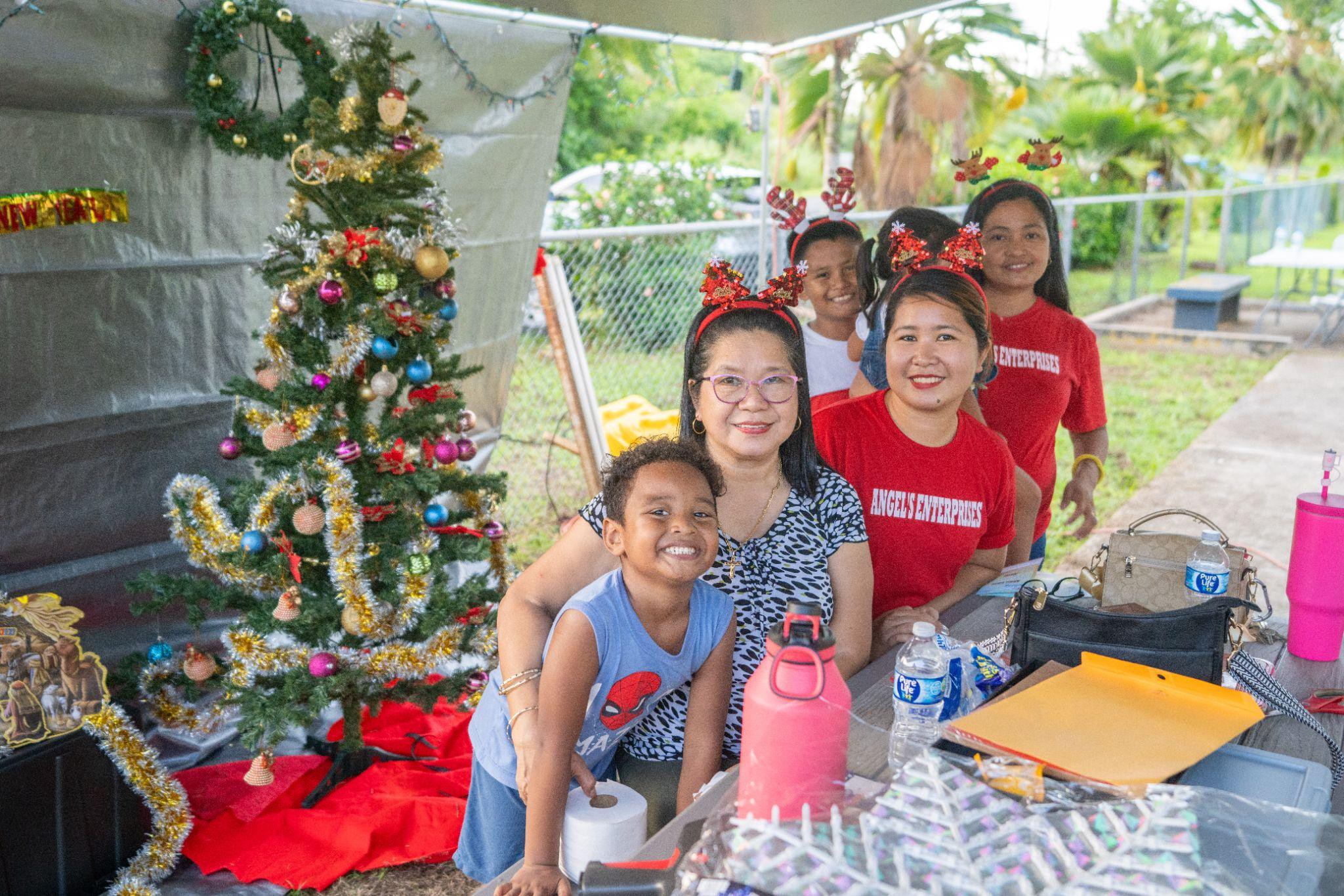 Vendors at the Rota SBDC-sponsored Christmas In July event pose for a spirited photo amid the cheerful festivities.