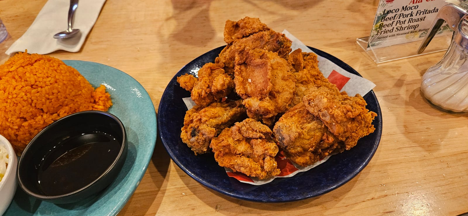 The six-piece chicken meal comes with with red rice and coleslaw.