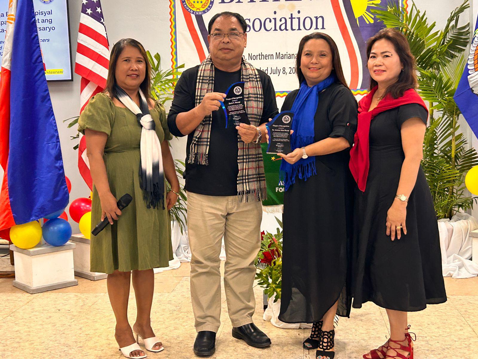 The Bayani Association presents  plaques of recognition to the outgoing president, Annamae Adaza-Mayuga, and Mario Mayuga for their exceptional commitment and support. Also in photo are new Bayani president, Yolanda Acode de Ramos, left, and Secretary Leonila C. Mendoza, right.