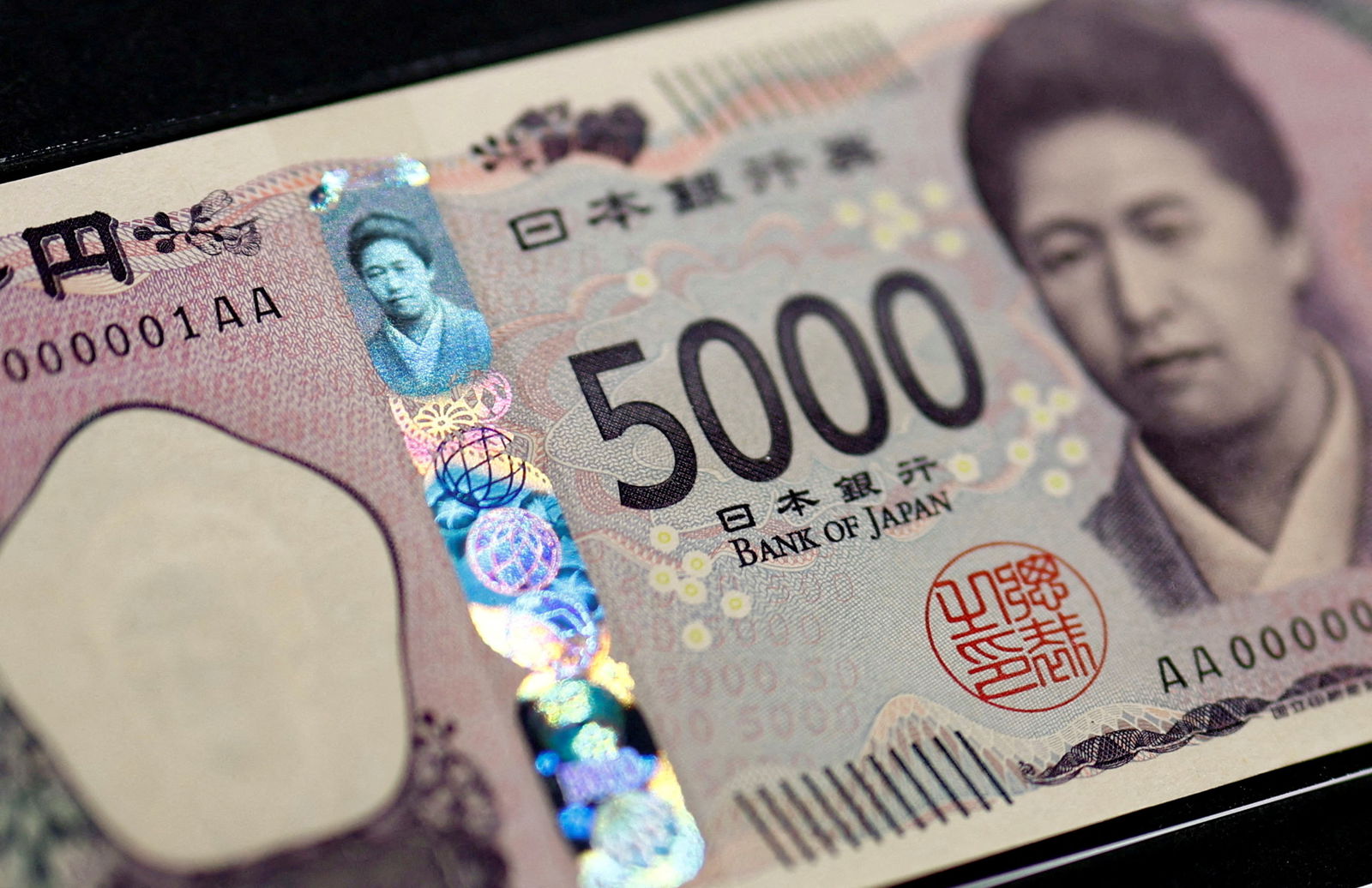 Holograms, which show different images and colors depending on the angle at which they are viewed, are seen on the new Japanese 5,000 yen banknote as the new note is displayed at a currency museum of the Bank of Japan, on the day the new notes of 10,000 yen, 5,000 yen and 1,000 yen went into circulation, in Tokyo, Japan, July 3, 2024.