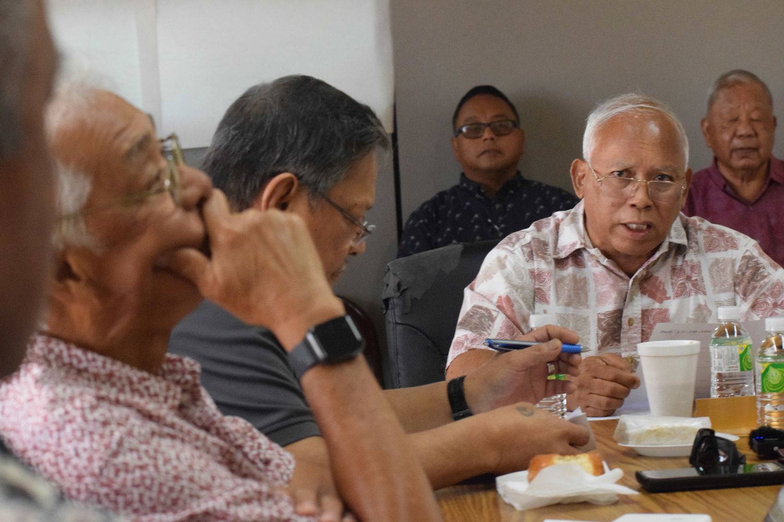 Commonwealth Ports Authority Board Chair Jose C. Ayuyu, second right, speaks as board member Thomas Villagomez listens during a meeting on Tuesday. In the background are Lt. Gov. David M. Apatang and one of his staff members.