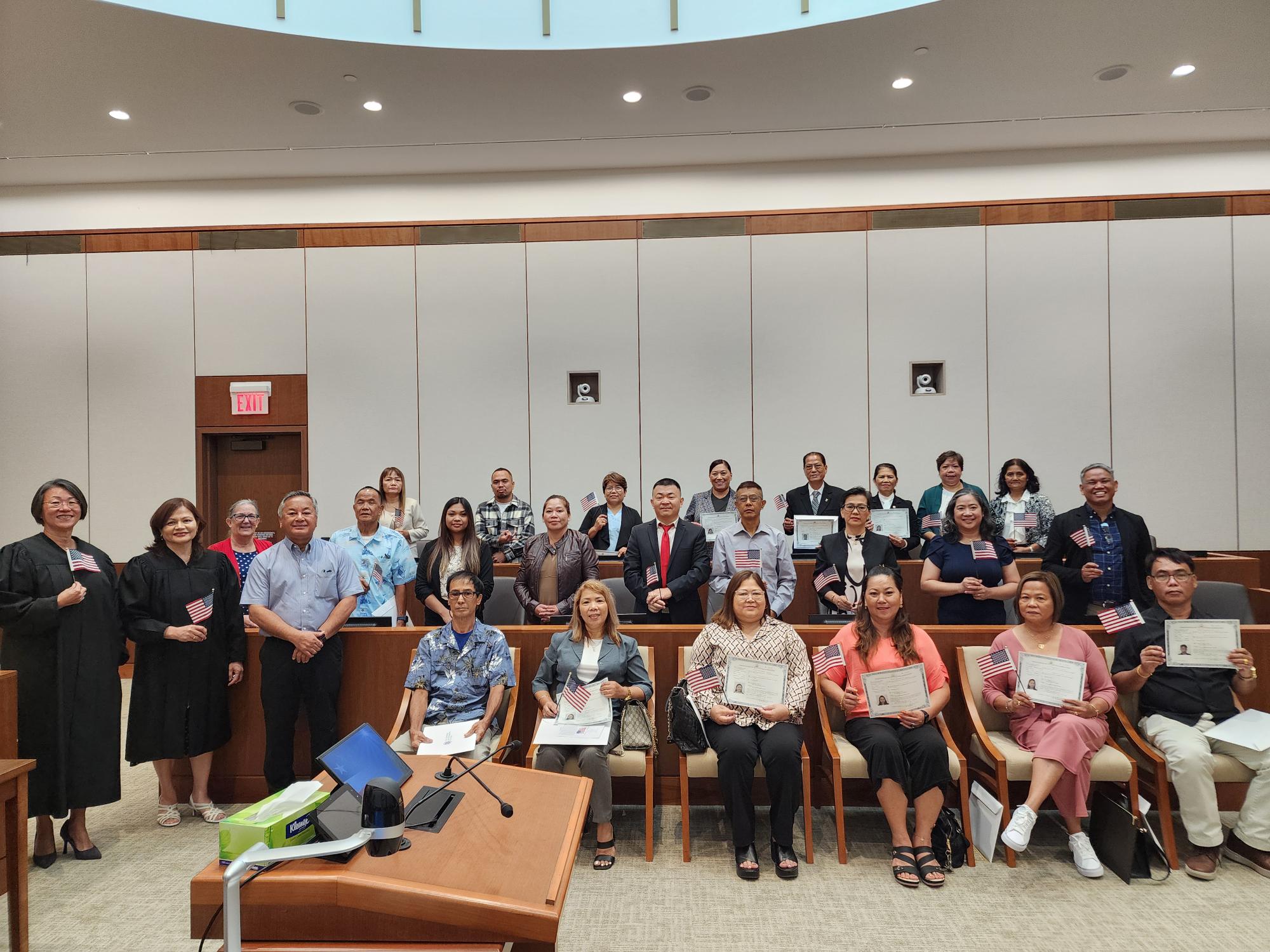 Court for the NMI on Monday, July 1. Also in the photo are Chief Judge Ramona V. Manglona, Superior Court Associate Judge Teresa Kim-Tenorio, Triple J Enterprises Vice President Michael Sablan and USCIS officer Patricia Phelan. 