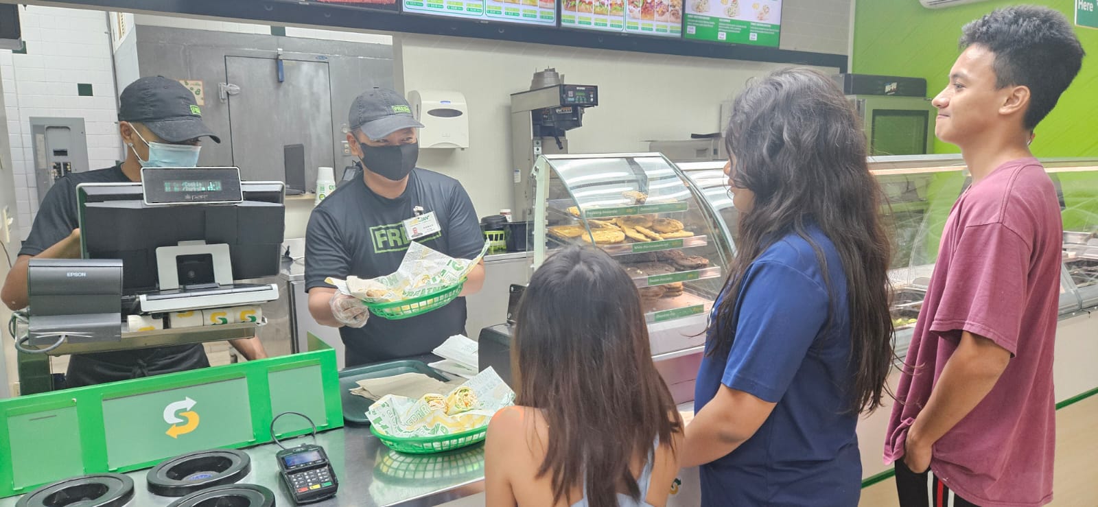 Damian Lastimado Jr., store supervisor, completes the wrap orders.