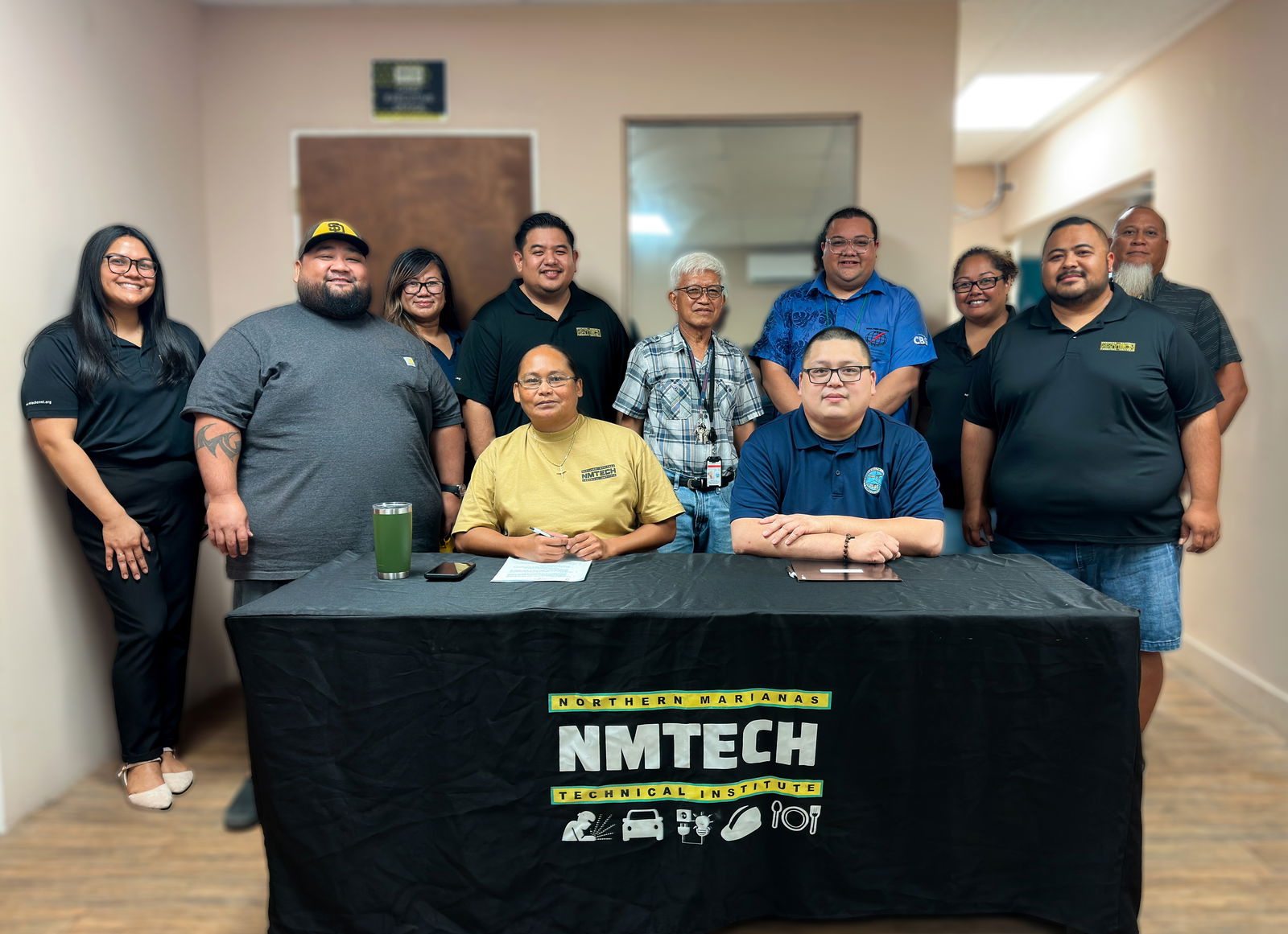 NMTech CEO Jodina Attao and CUC Human Resources Manager Francisco Matsunaga Jr., along with staff from both organizations, pose for a photo following the signing of an MOU that enhances the partnership between NMTech and CUC.