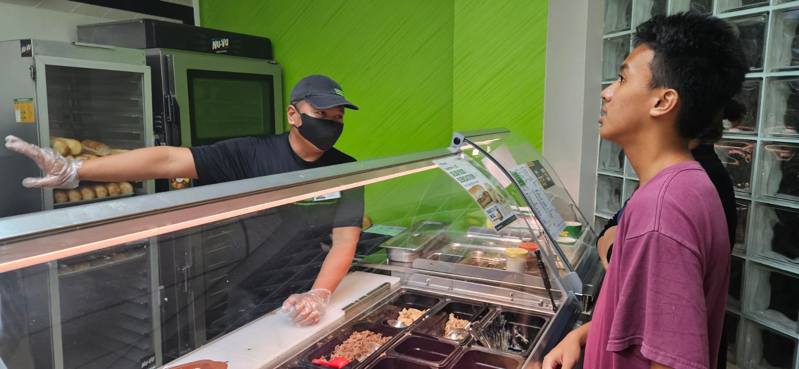 Damian Lastimado Jr. explains the different wraps to a customer.