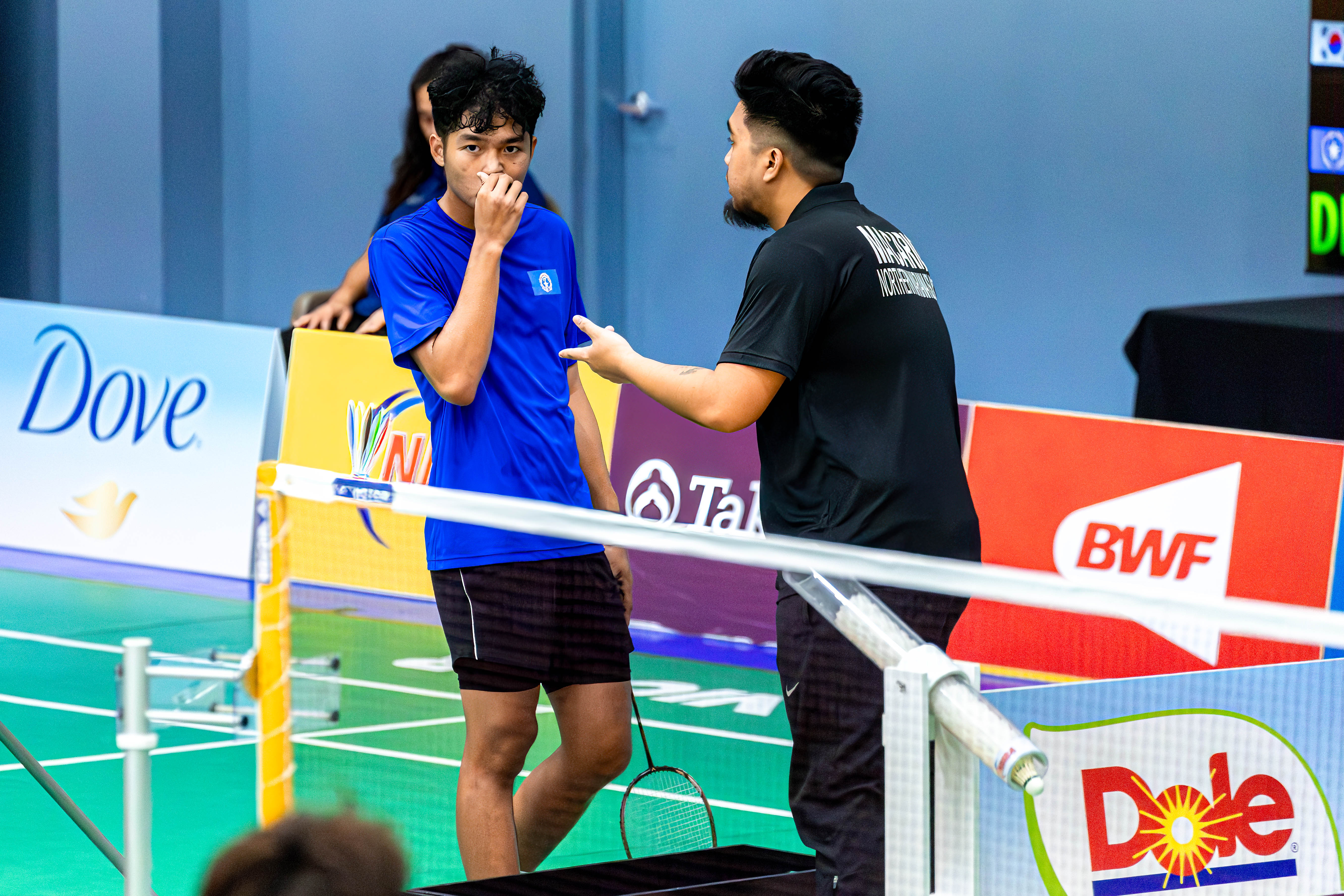 The NMI's Sean Dizon listens to coach Ezekiel (not Daniel) Macario during a break from a men's singles match of the Dove Saipan International 2024 held at the Ada gym Wednesday.