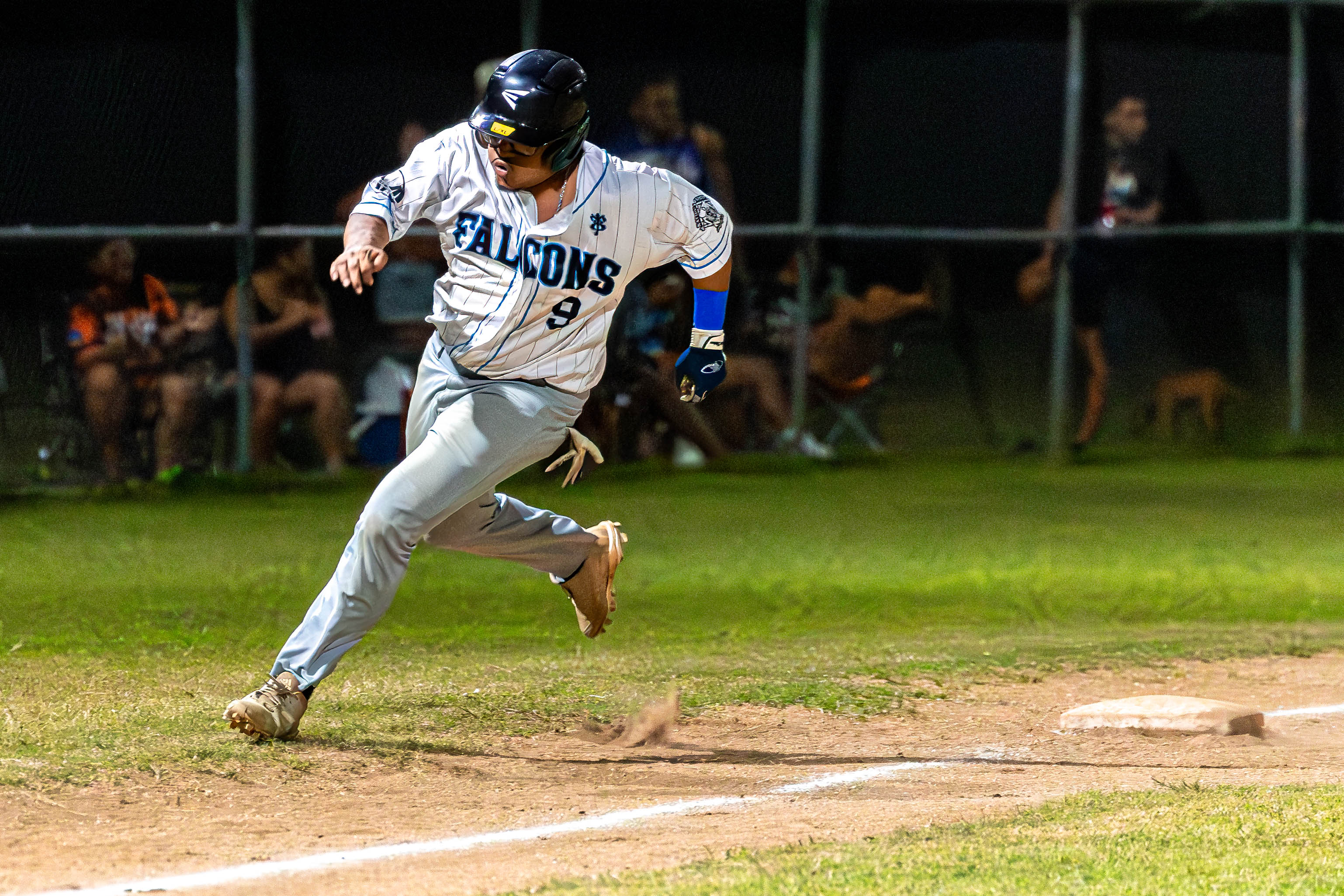 Falcon's #9 Third Baseman Ian Norita sprints towards home to score a run.