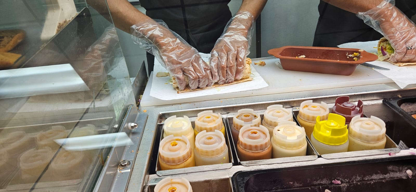 A Subway staff member prepares a wrap.