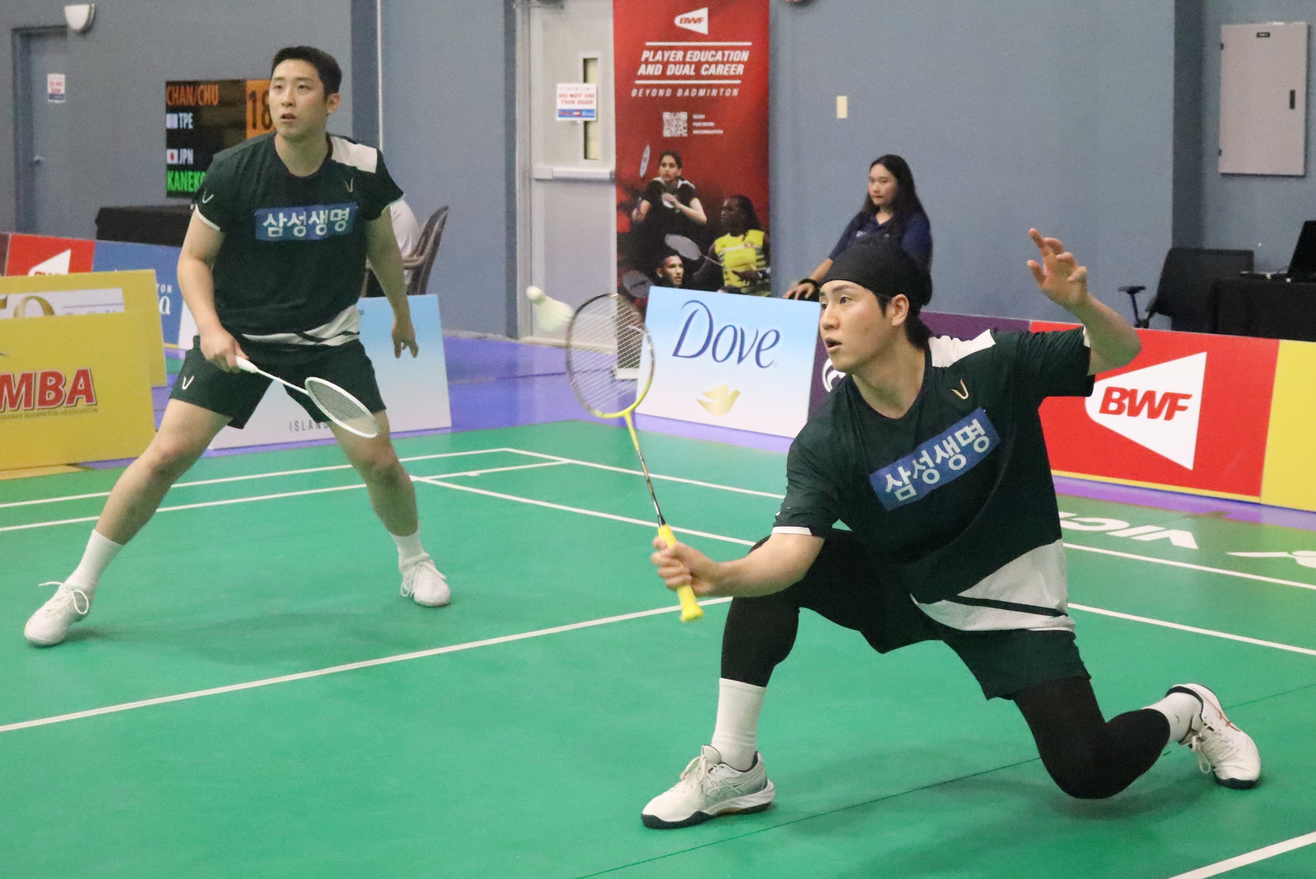 South Korea's Heo Kwang Hee reaches for the save alongside teammate Jung Jae Woo during a men's doubles match against Japan's Tori Aizawa and Daisuke Sano in the Dove Saipan International 2024 at the Ada gym Thursday.