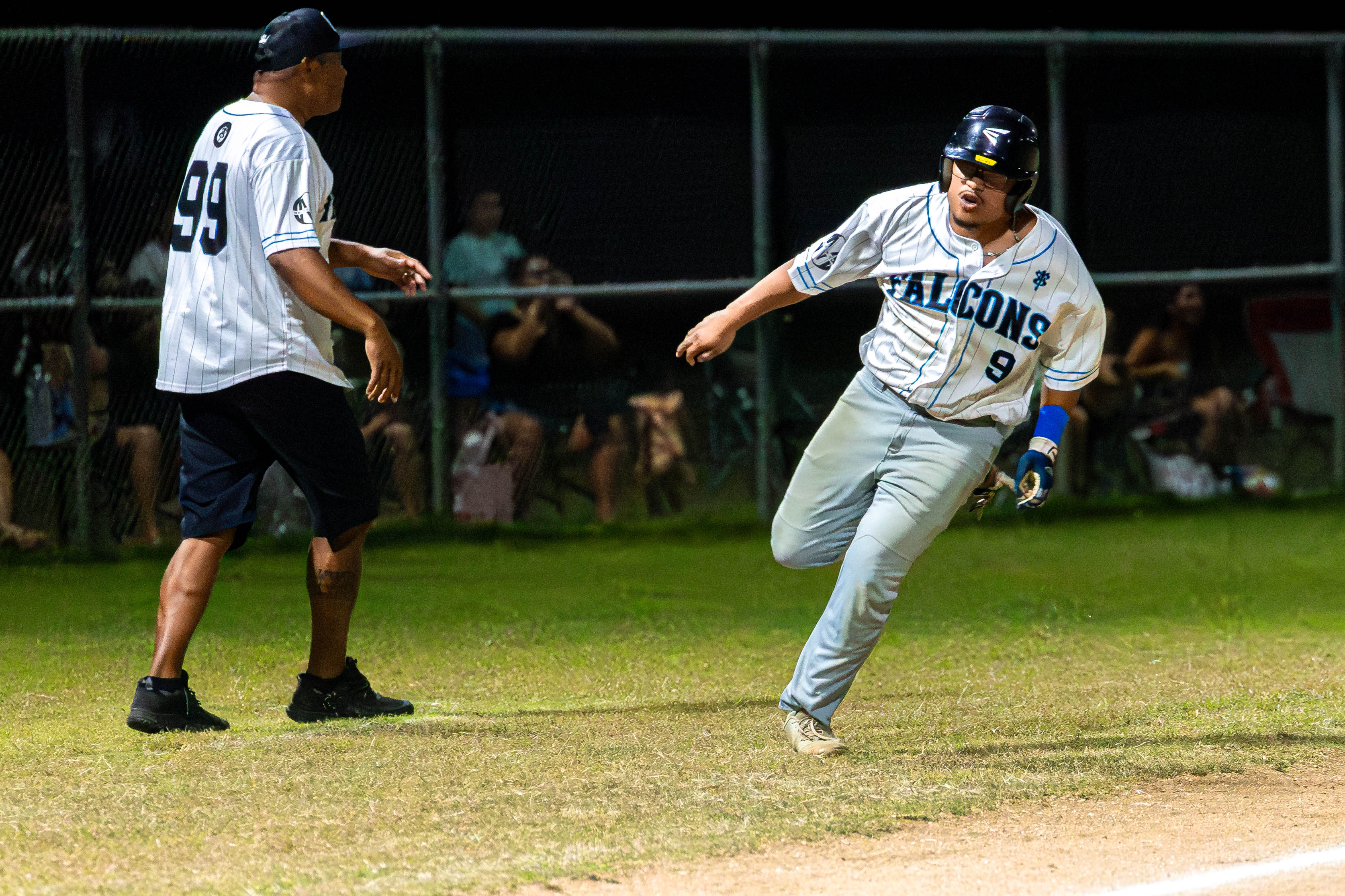 Falcon's #9 Third Baseman Ian Norita sprints towards home to score a run.