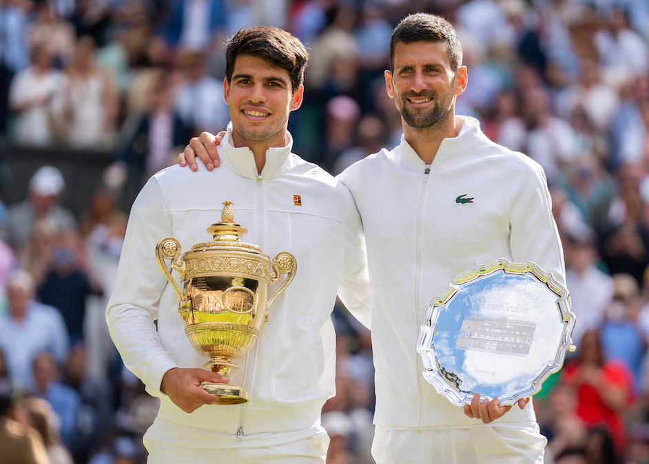 Carlos Alcaraz of Spain and Novak Djokovic of Serbia pose with their trophies after Wimbledon’s men’s singles final on day 14 at All England Lawn Tennis and Croquet Club in London, England on July 14, 2024.