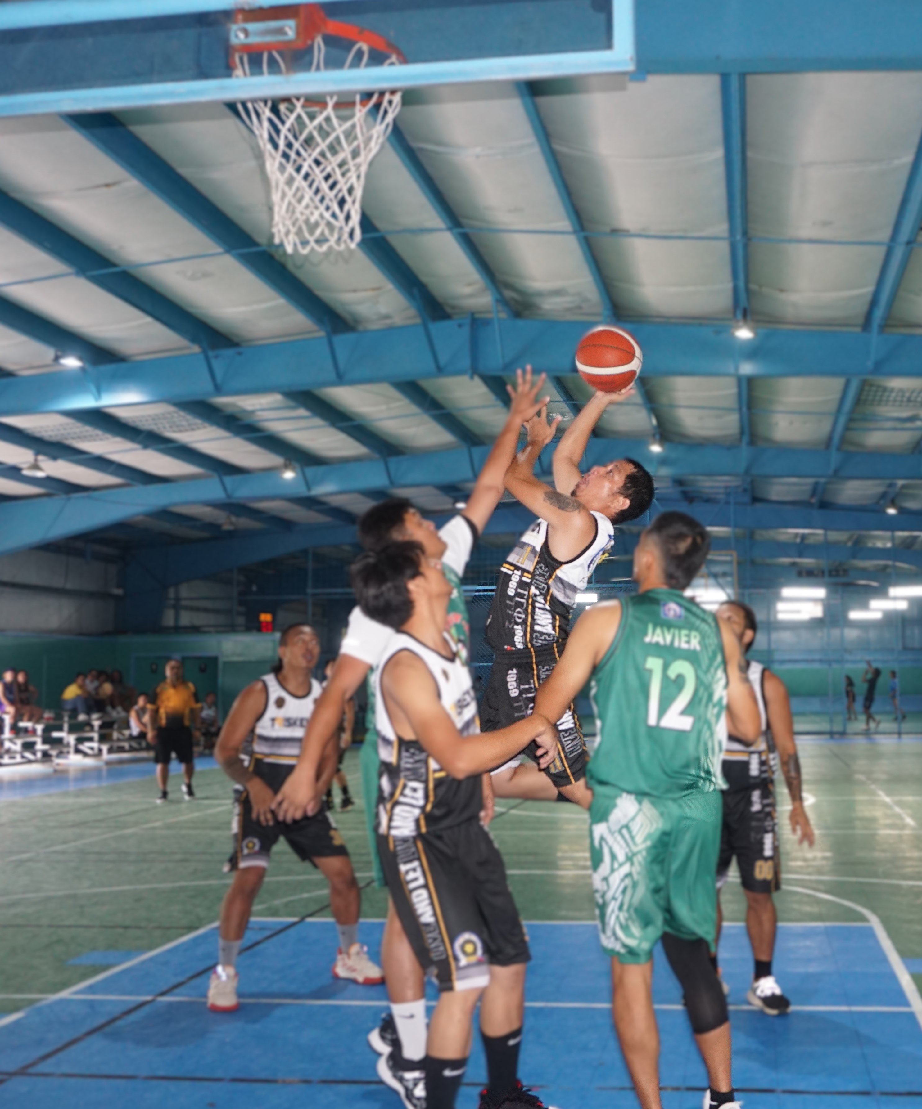 Triskelion's Jan Quinto takes the hook shot over two defenders during a game against Islander Rent-A-Car in the Destroyers Basketball Club Invitational Basketball League 2024 at the TSL Sports Complex on Sunday.