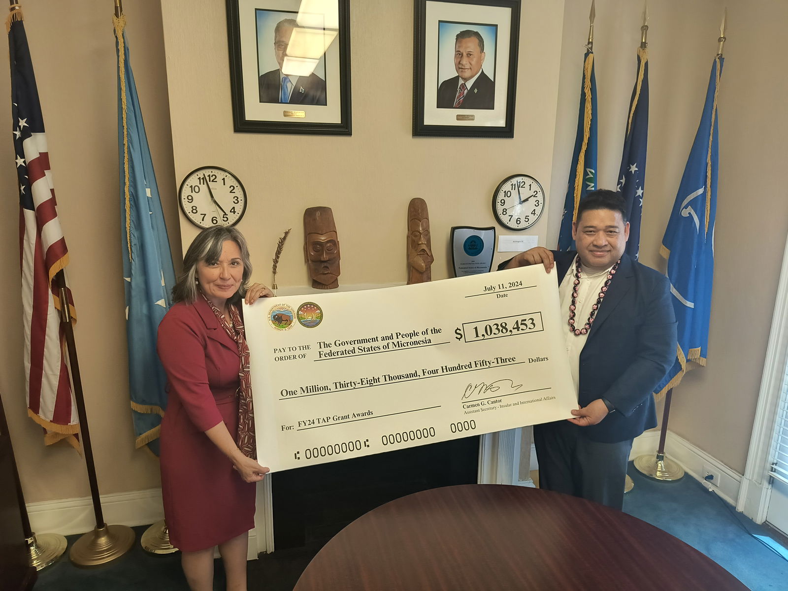 FSM Ambassador to the U.S. Jackson Soram and Interior’s Assistant Secretary for Insular and International Affairs Carmen G. Cantor hold a ceremonial check for over $1 million.