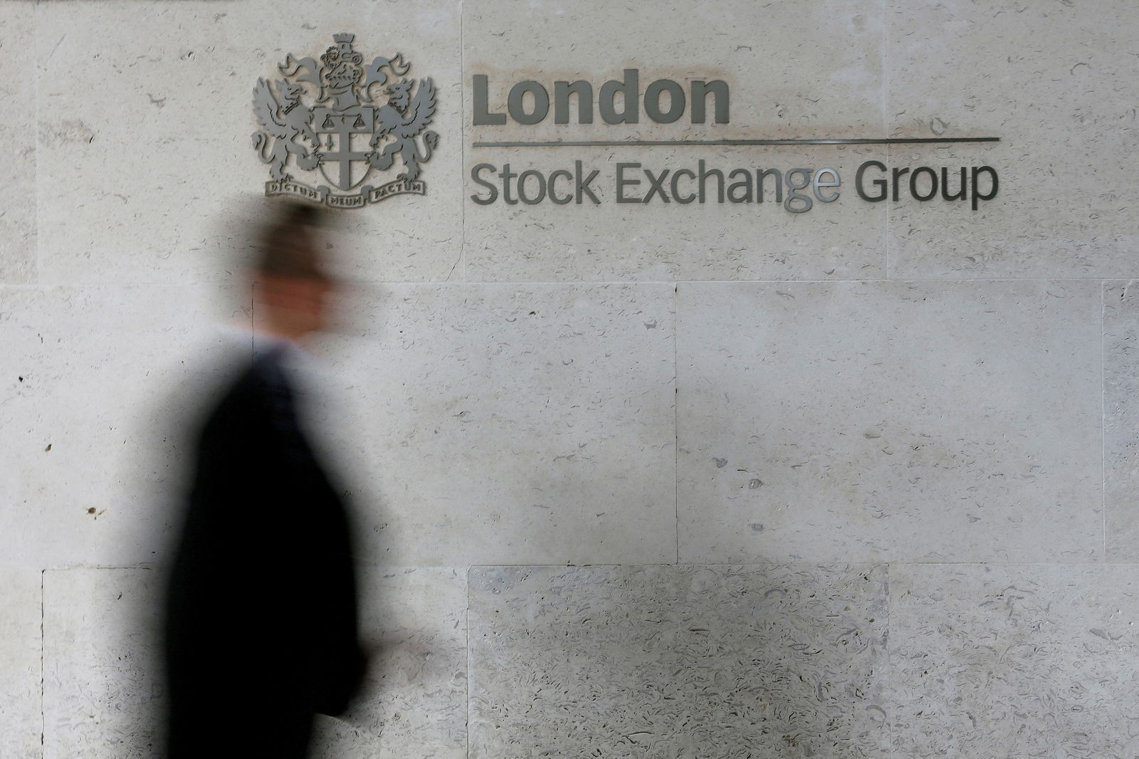 A man walks past the London Stock Exchange in the City of London, Oct. 11, 2013.