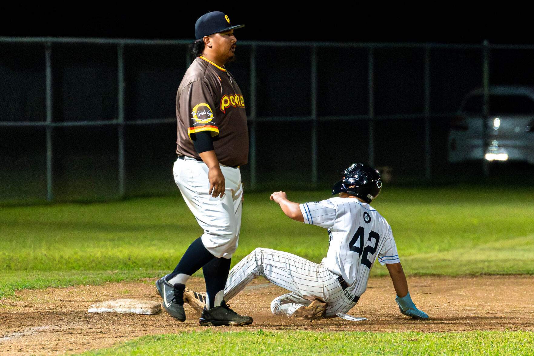 The Falcons’ Tonchu Norita slides to third for a stolen base capitalizing off an error during a game against the Padres in the 2024 Tan Holdings Saipan Baseball League at the Francisco "Tan Ko" Palacios Baseball Field on Wednesday.