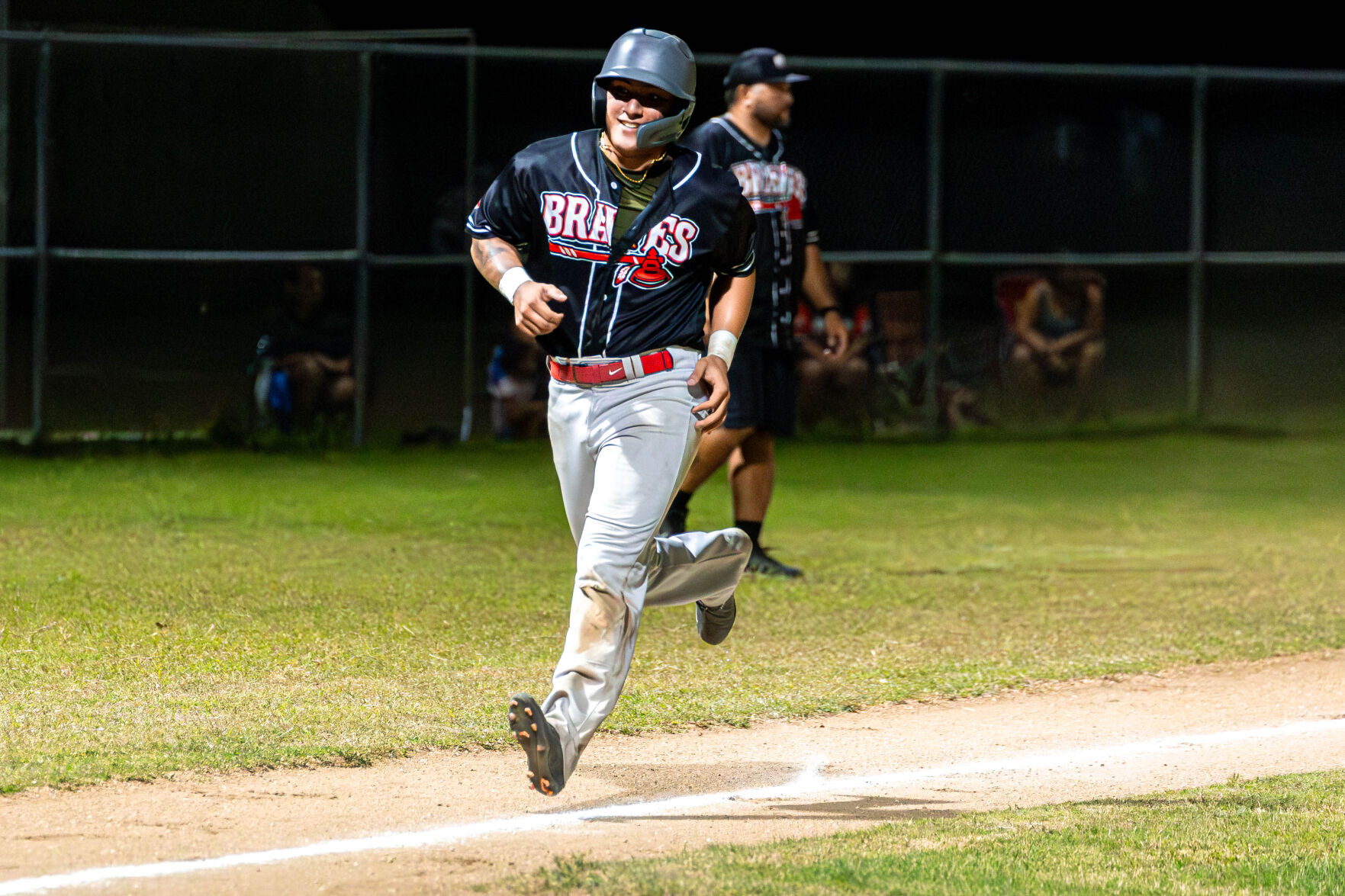 The Braves' Josenio Alvarez smiles as he reaches home plate for a scored run during a game against the Royals in the 2024 Tan Holdings Saipan Baseball League at the Francisco "Tan Ko" Palacios Baseball Field on Monday.