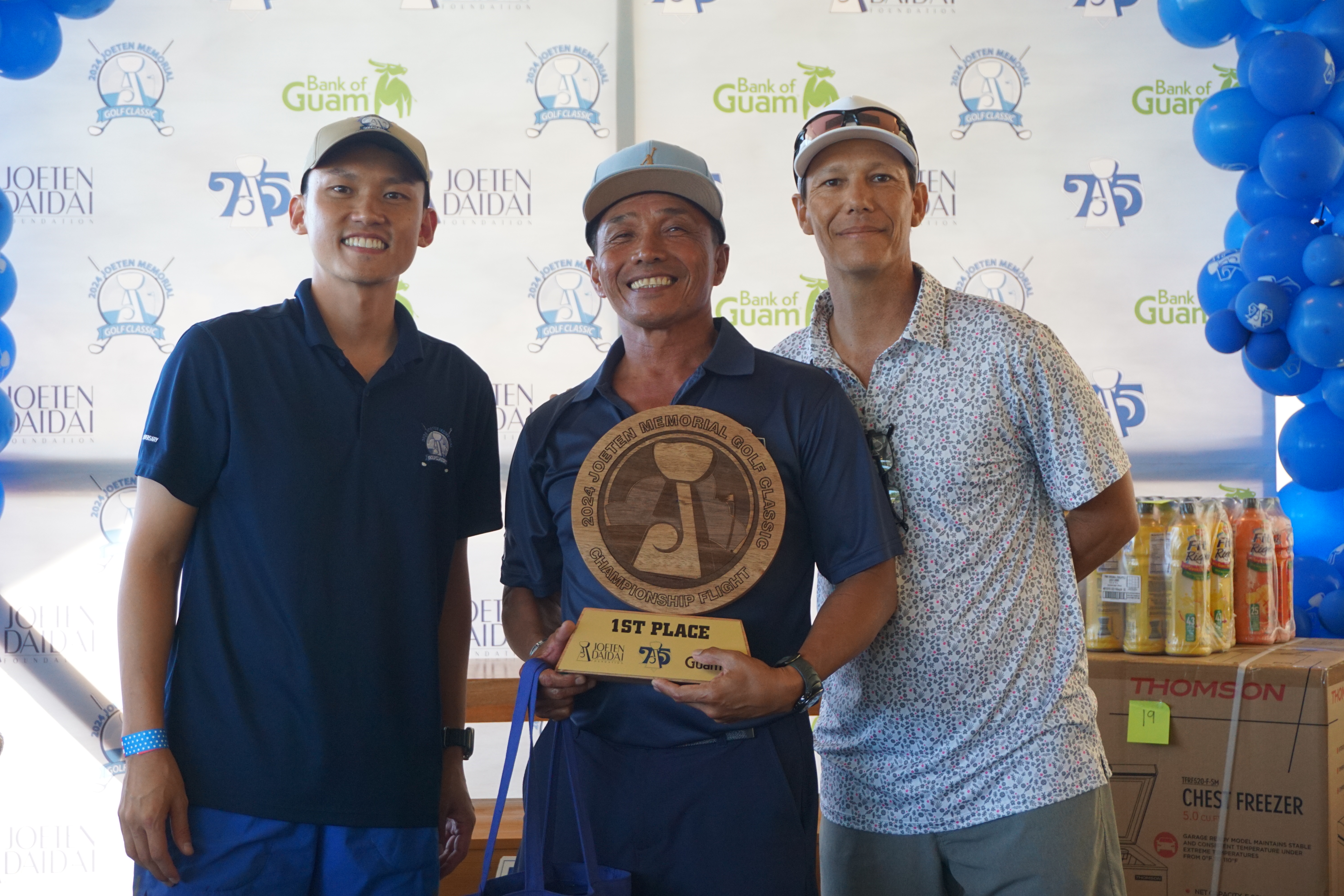 Joe Sasamoto Jr., center, poses with the Championship Flight trophy alongside Committee Chair Shigeki Tenorio, left, and Tournament Director Peter "Dung" Tenorio during the awards ceremony of the 2024 Joeten Memorial Classic at LaoLao Bay Golf & Resort on Saturday.
