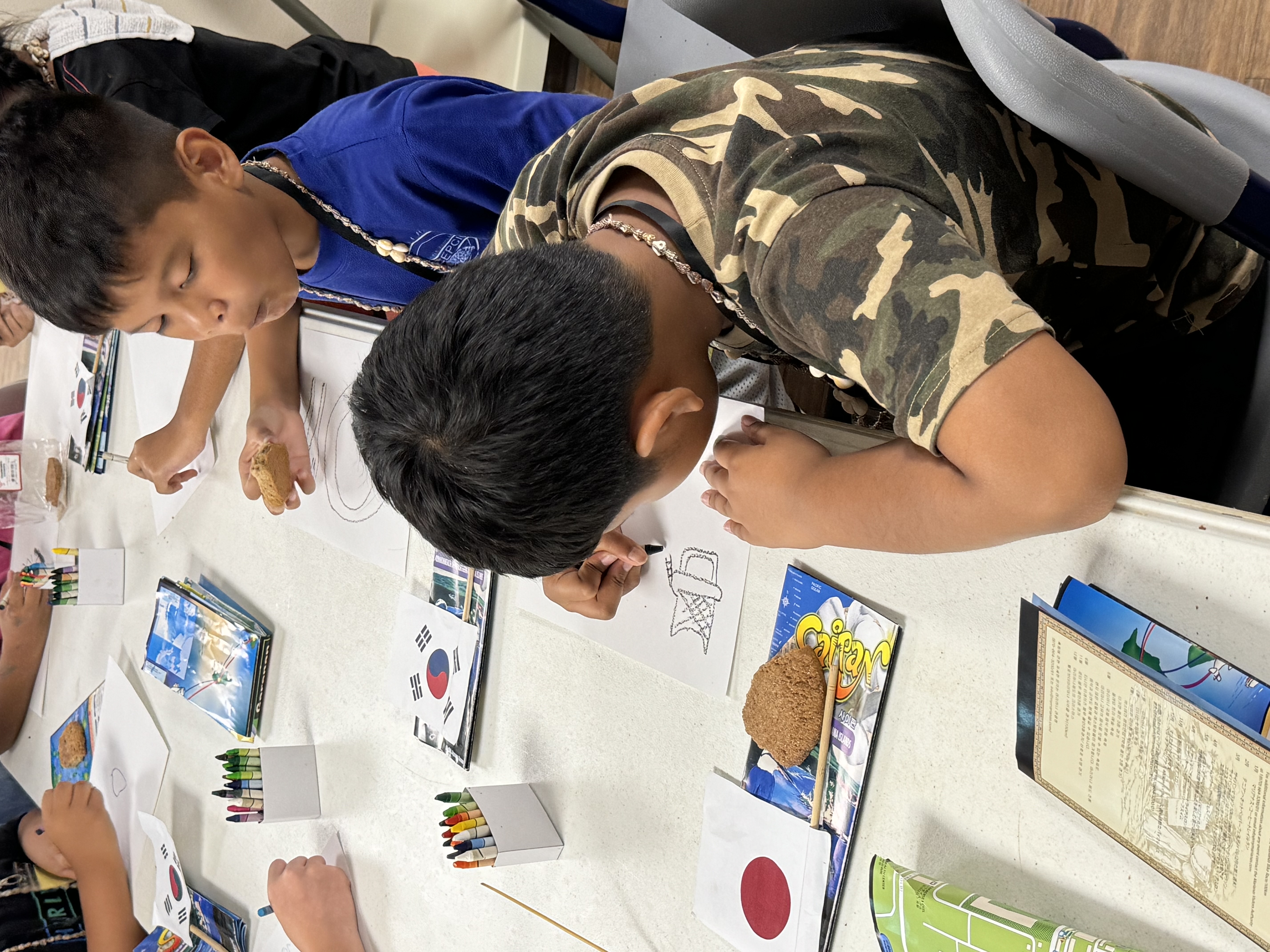Children draw what they would like to share with a visiting friend during outreach of the Marianas Tourism Education Council and Marianas Visitors Authority on July 24, 2024, in Koblerville.