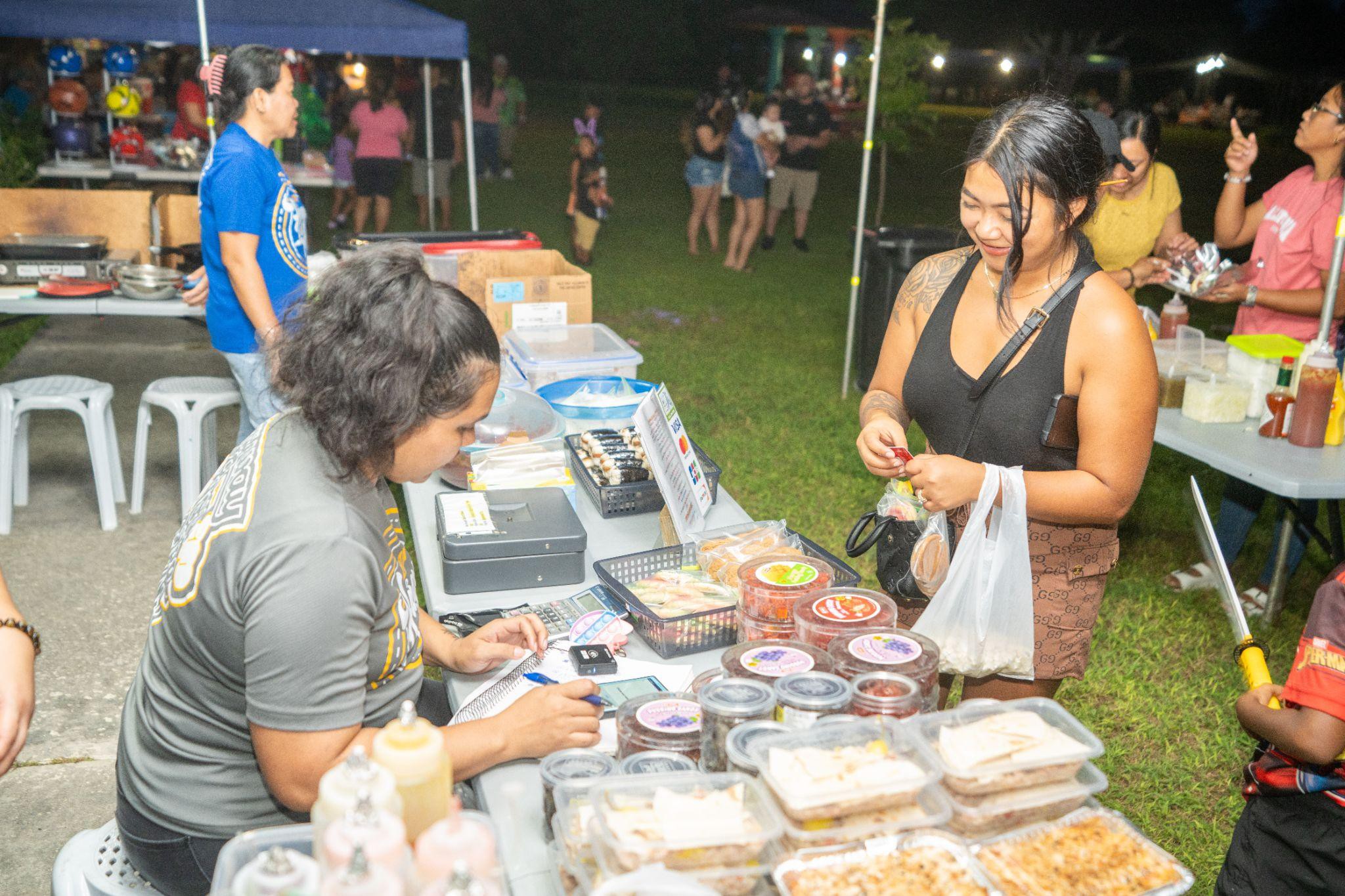Residents from Rota support local vendor Hagu La'mun at the Rota SBDC Christmas In July event.