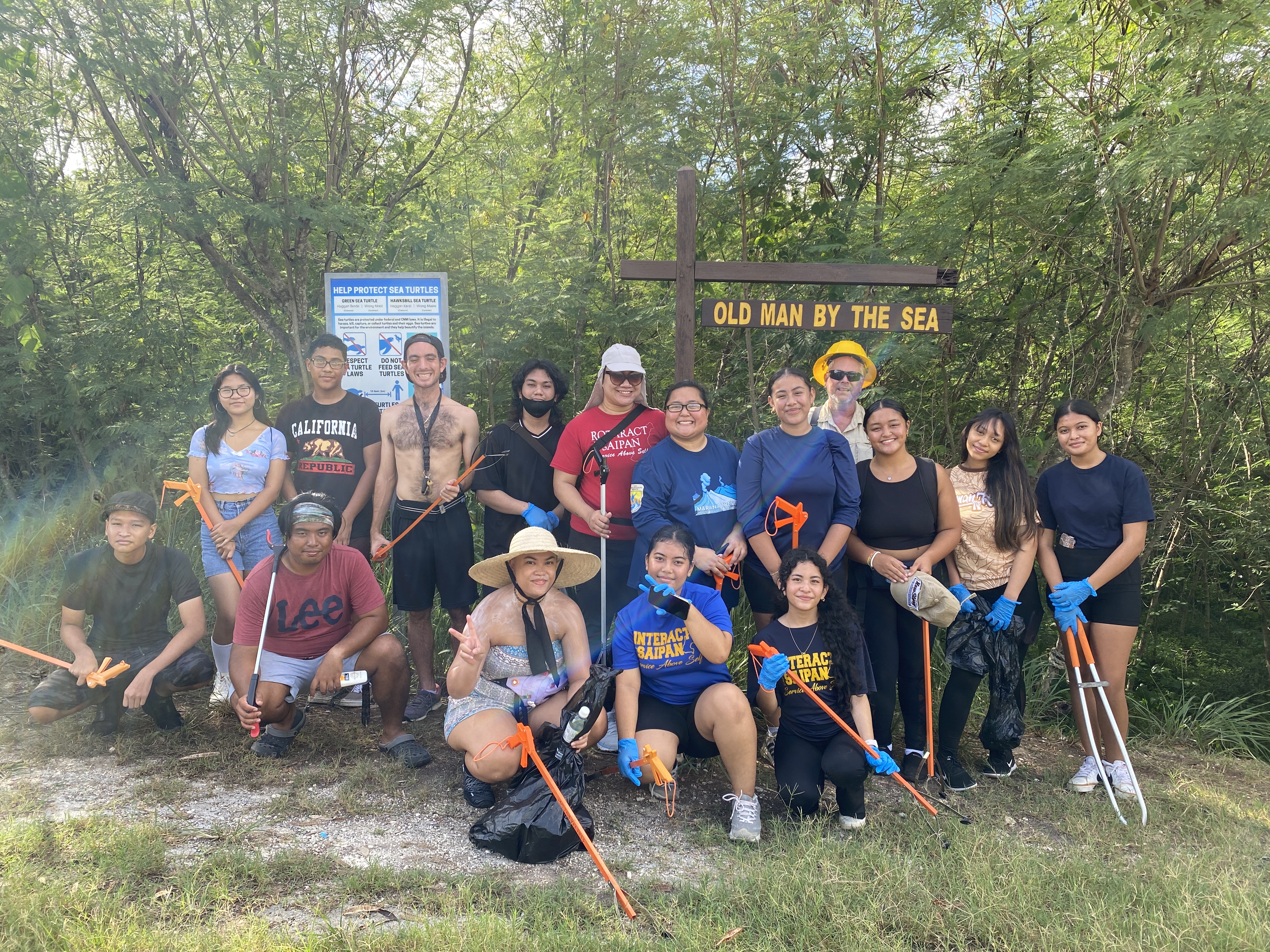 Members of the Interact and Rotaract clubs of Saipan and other community volunteers pose for a photo at the start of the hike that will take them to the Old Man by the Sea on Saturday.  