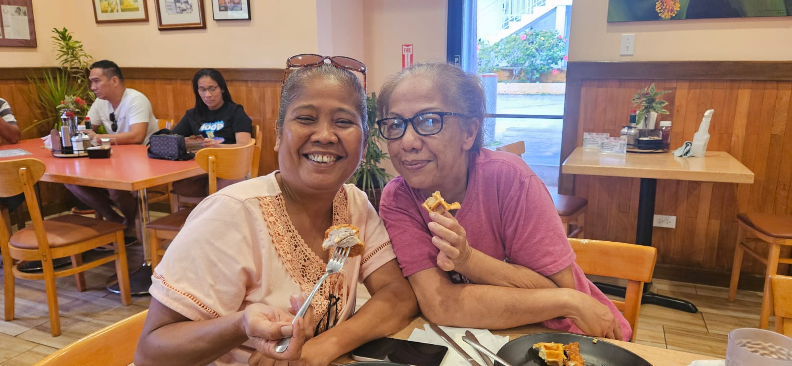 Vicenta Igisomar and Vicky Santos try the new Chicken Meal at Tan Marikita's Cafe of Hermans.