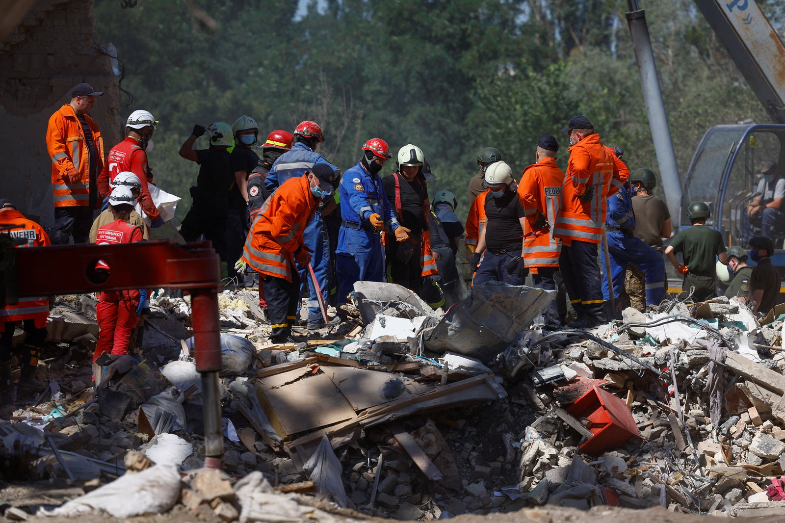 Rescuers remove debris as they search for people at the site where an apartment building was hit by a Russian missile strike in Kyiv, Ukraine, July 9, 2024.