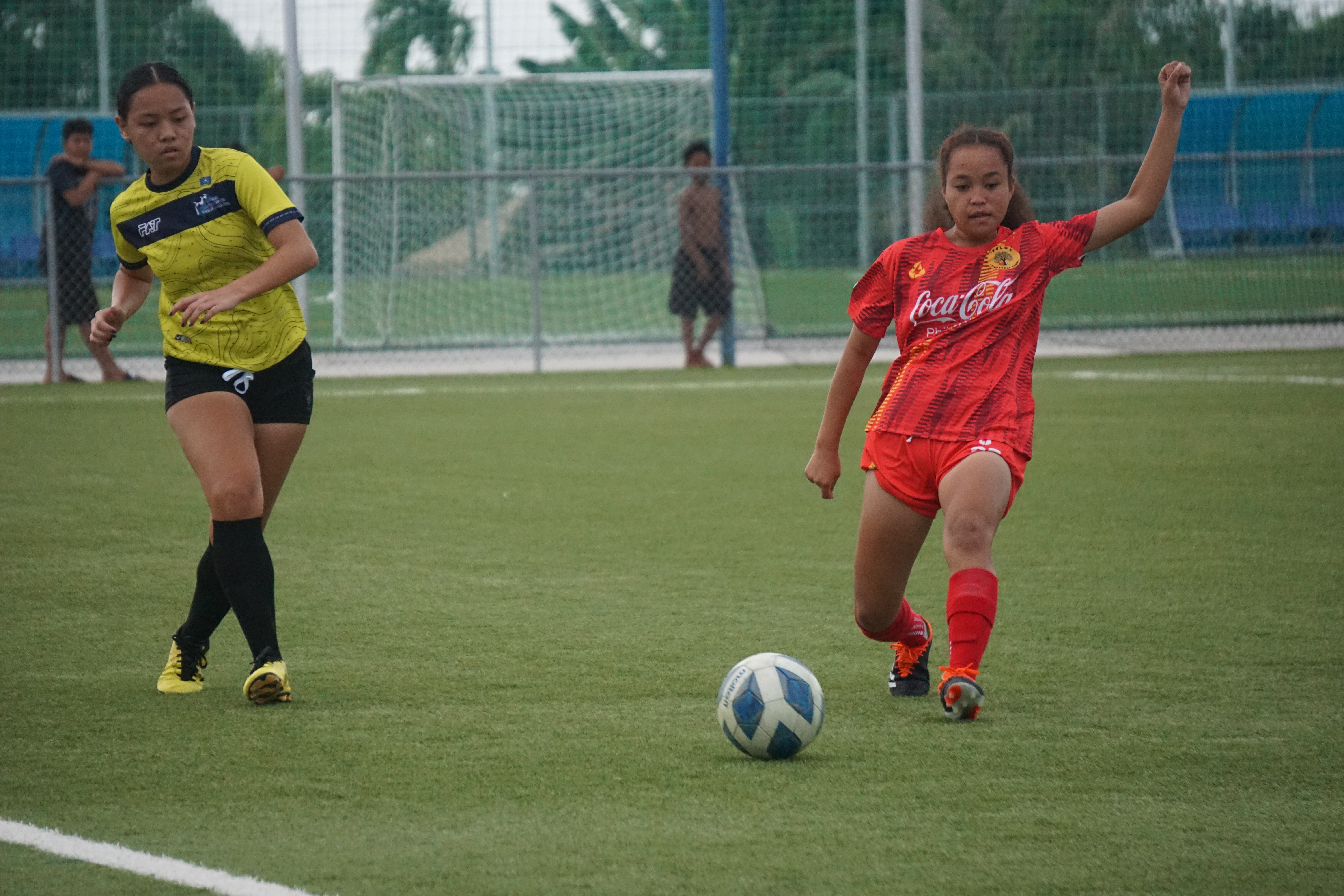 Aubrey Castro of the NMI Football Association Women’s Team passes forward as a Tuloy FC Women’s Team defender reaches for the interception during an LPK Cup match Thursday at the NMI Soccer Training Center in Koblerville.