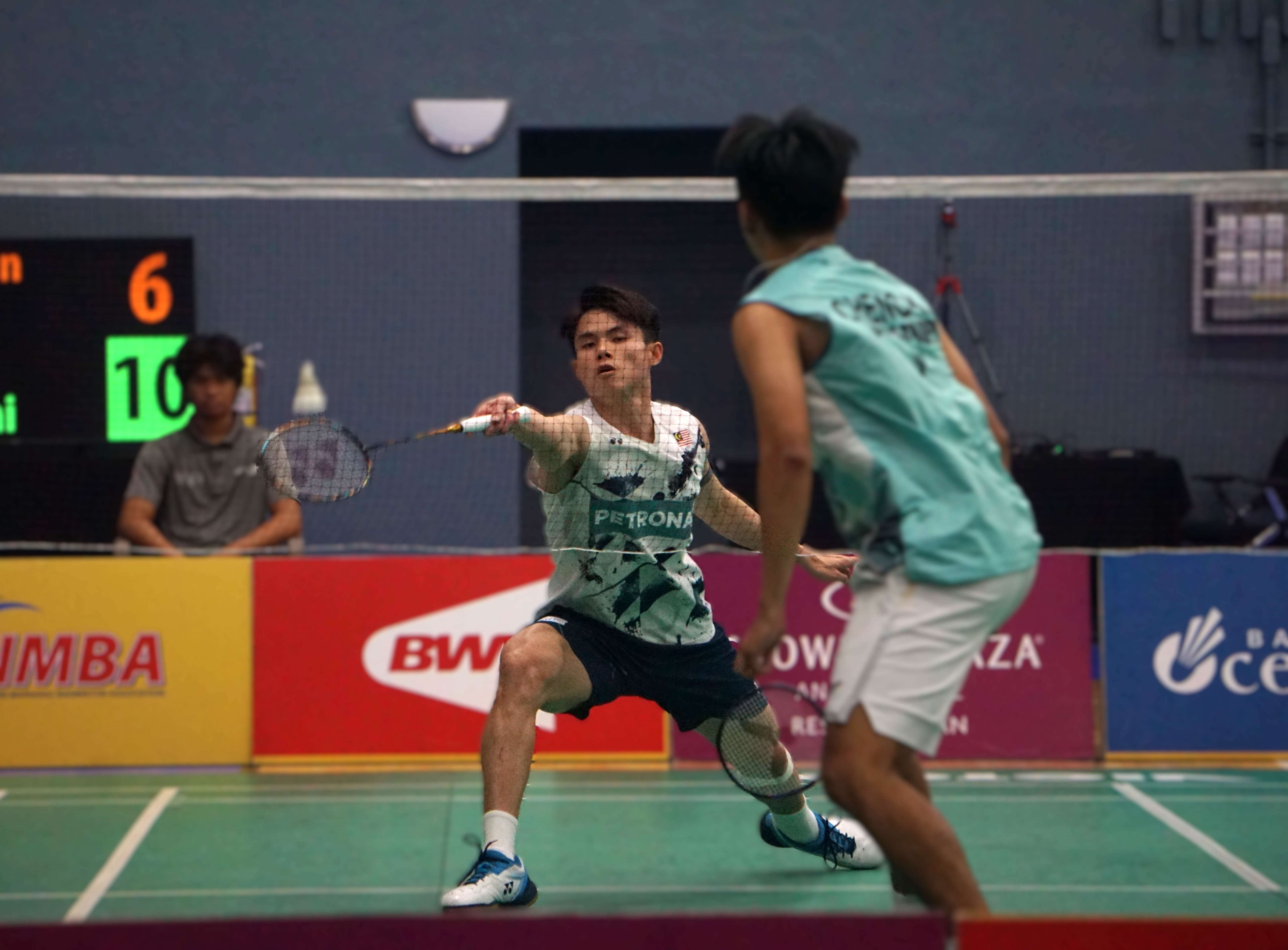 Malaysia's Justin Hoh reaches out for the lob return against Chinese Taipei's Cheng Kai during the men's singles finals of the Crowne Plaza Northern Marianas Open 2024 at the Ada gym on Sunday.